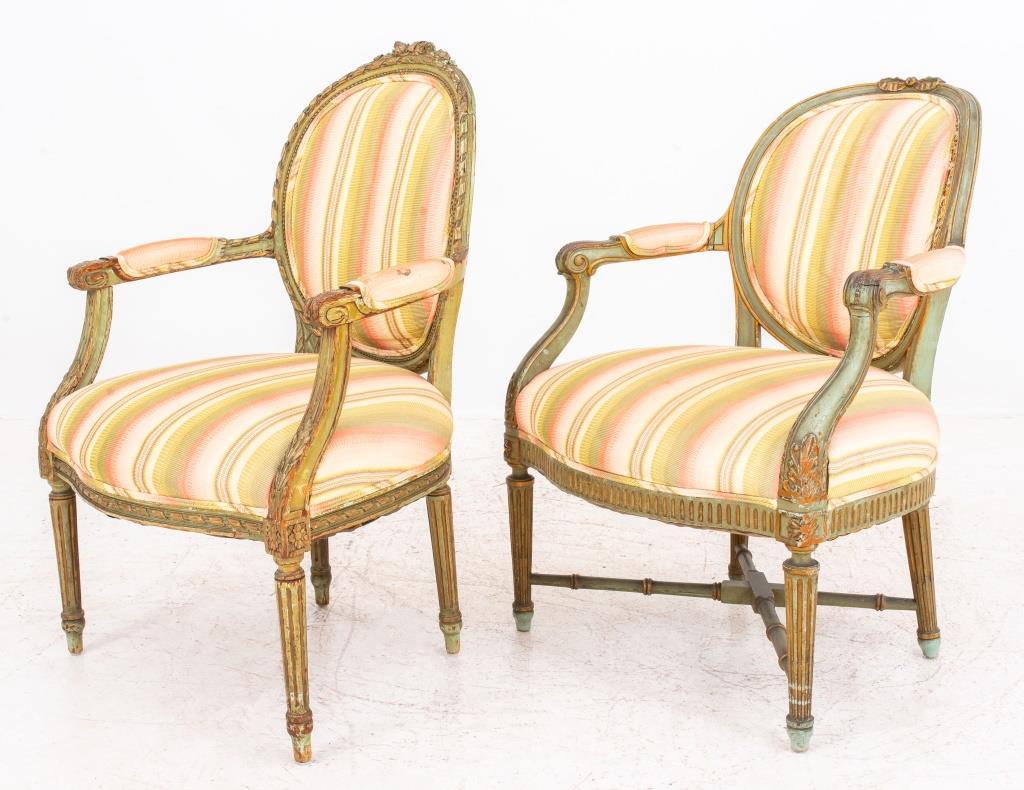Neoclassical Style Green-Painted Armchairs, two associated, one in the French Louis XVI  taste with carved crest rail above an upholstered back with down swept acanthus carved arms above a bow-front shaped seat on fluted legs, the other in the