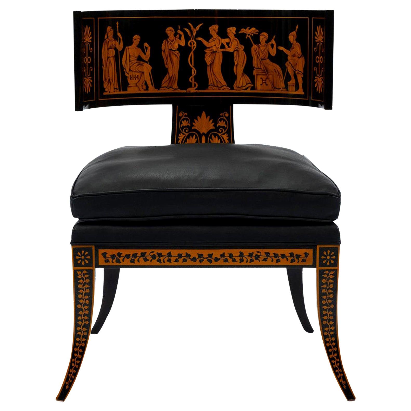 A large scale Italian neoclassical chair finely crafted in ebony and pau marfim veneers. Extraordinary details include a frieze of seven classical figures with floral and foliage detailing. Chair is upholstered in black leather with a loose down