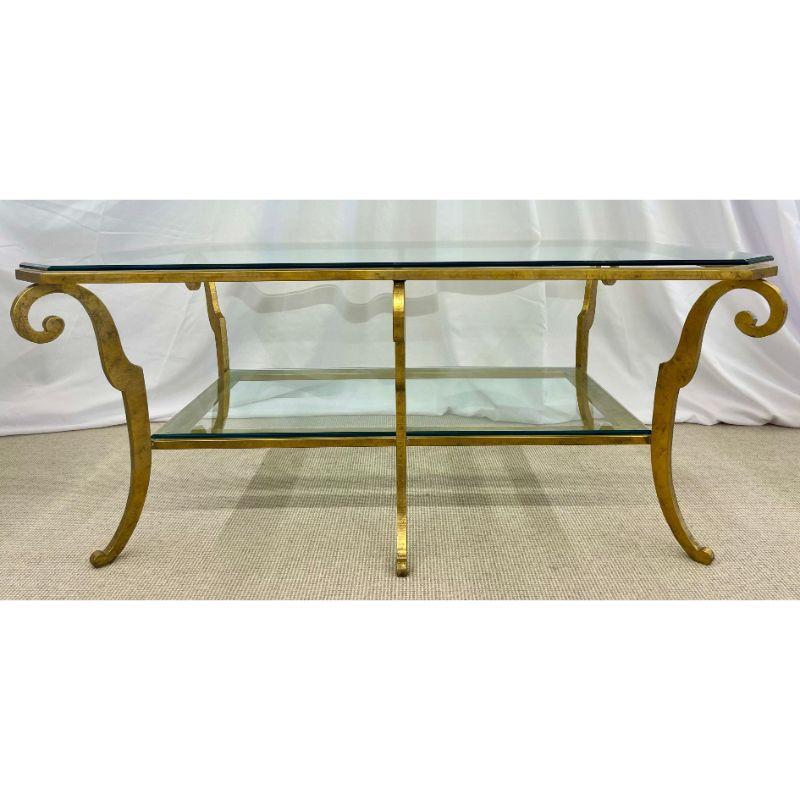 Neoclassical Style Large Gilt Metal Frame Coffee Table, Glass Top, French. The base having scroll frame supporting a lower glass shelf leading to a larger beveled glass upper table top.