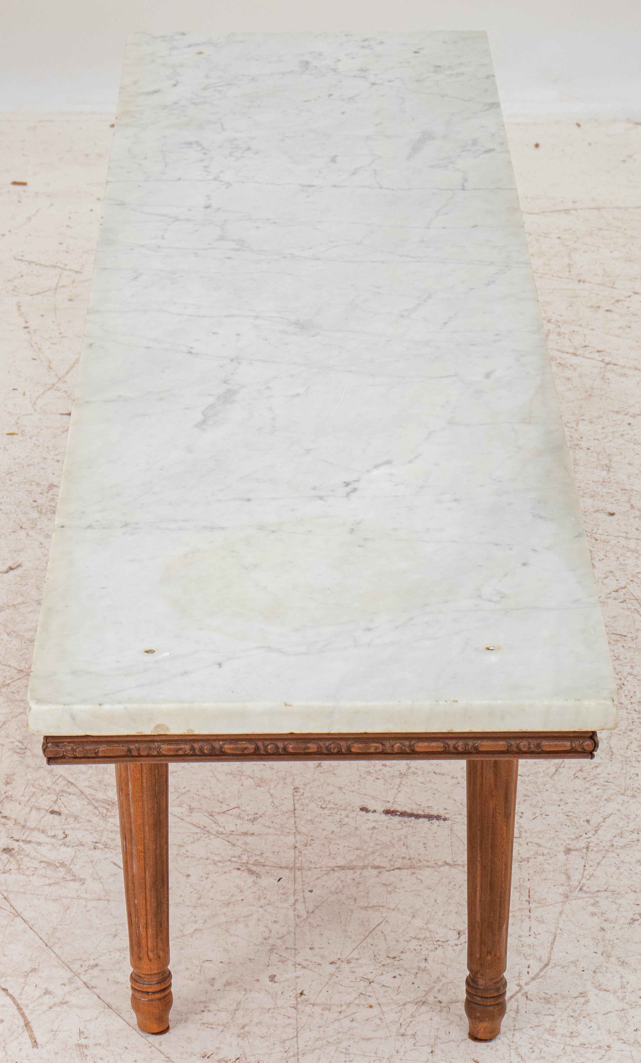 Neoclassical Style wood low table or side table with Carrara marble top, raised on four fluted tapered legs, circa early twentieth century. Measures: 16.5