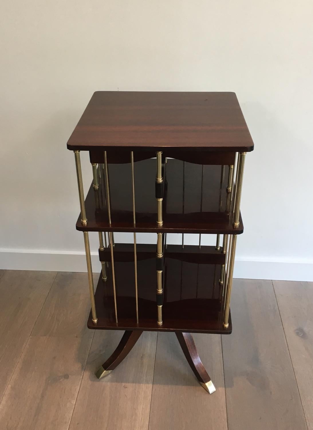 This very nice neoclassical style revolving library is made of mahogany and brass. This bookcases is a very elegant model. This is a nice French work, in the style of Maison Jansen, circa 1950