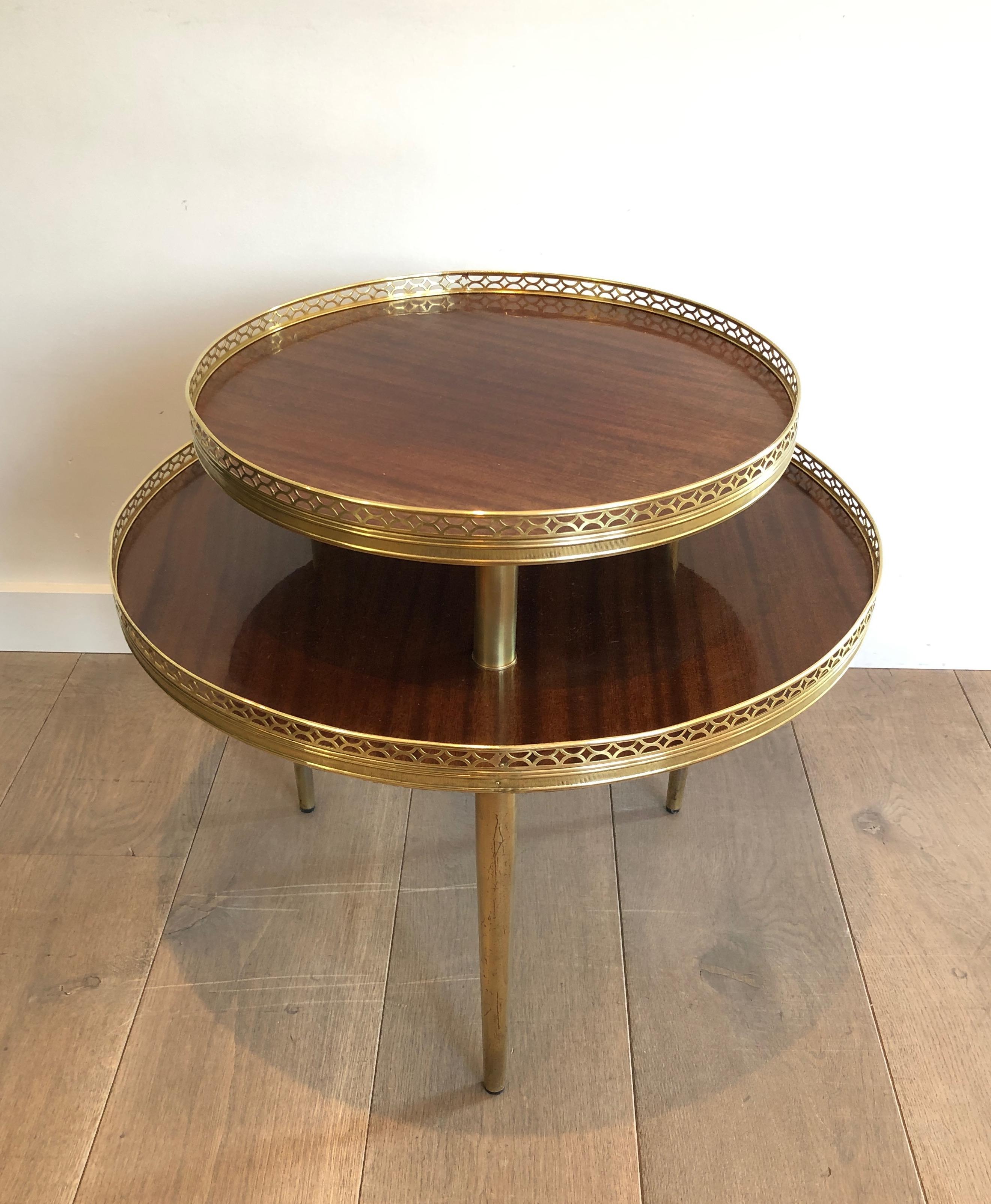 This neoclassical style tripode gueridon is made of mahogany, brass and gilt metal. This is a French work, circa 1940.