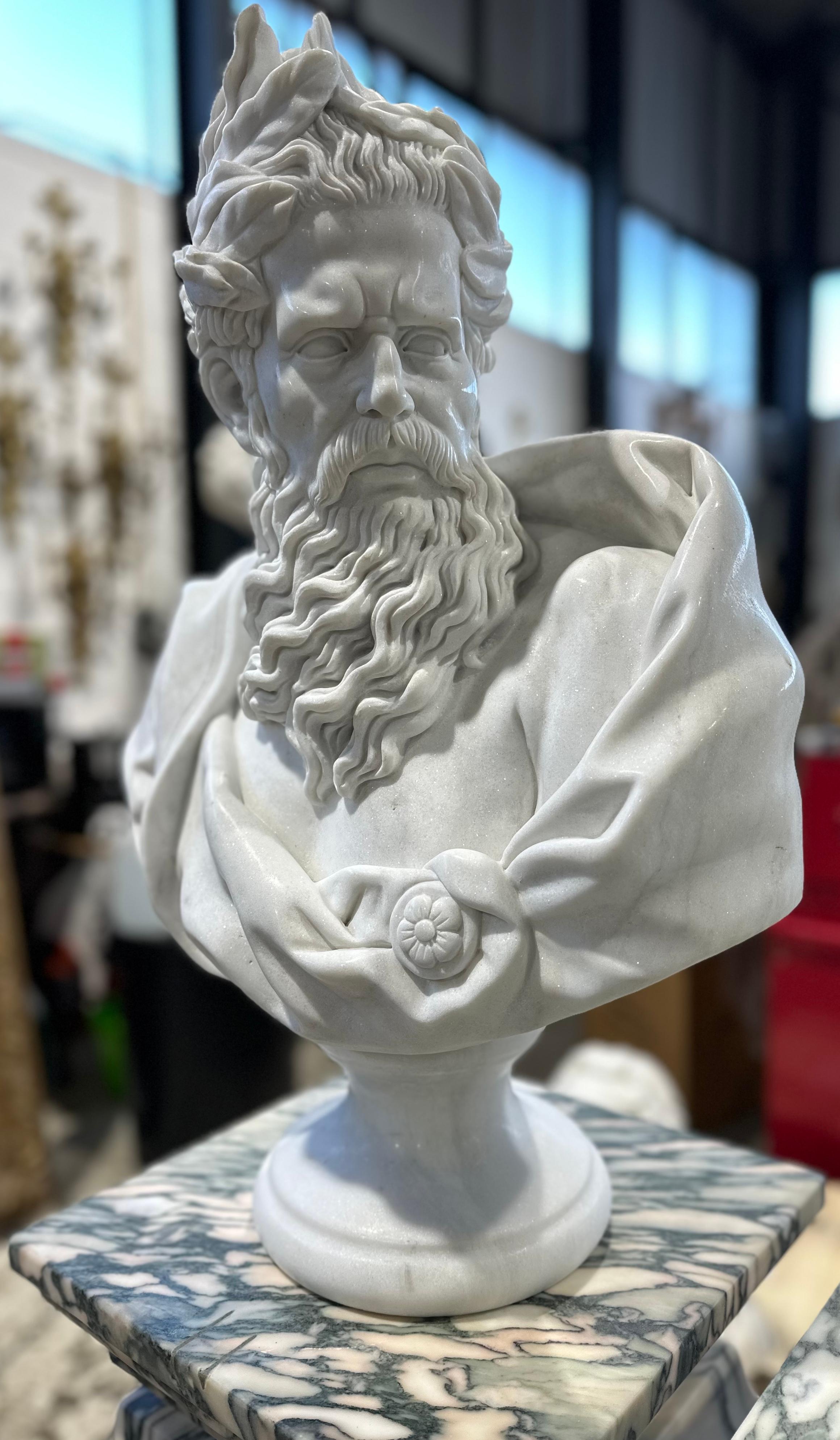 A wonderful hand-carved marble male Neoclassical style bust on a decorative marble plinth. Clear features and carving to the drapery, hair and beard. The texture of the hair contrasts beautifully with the smooth creases of the clothing. A decorative