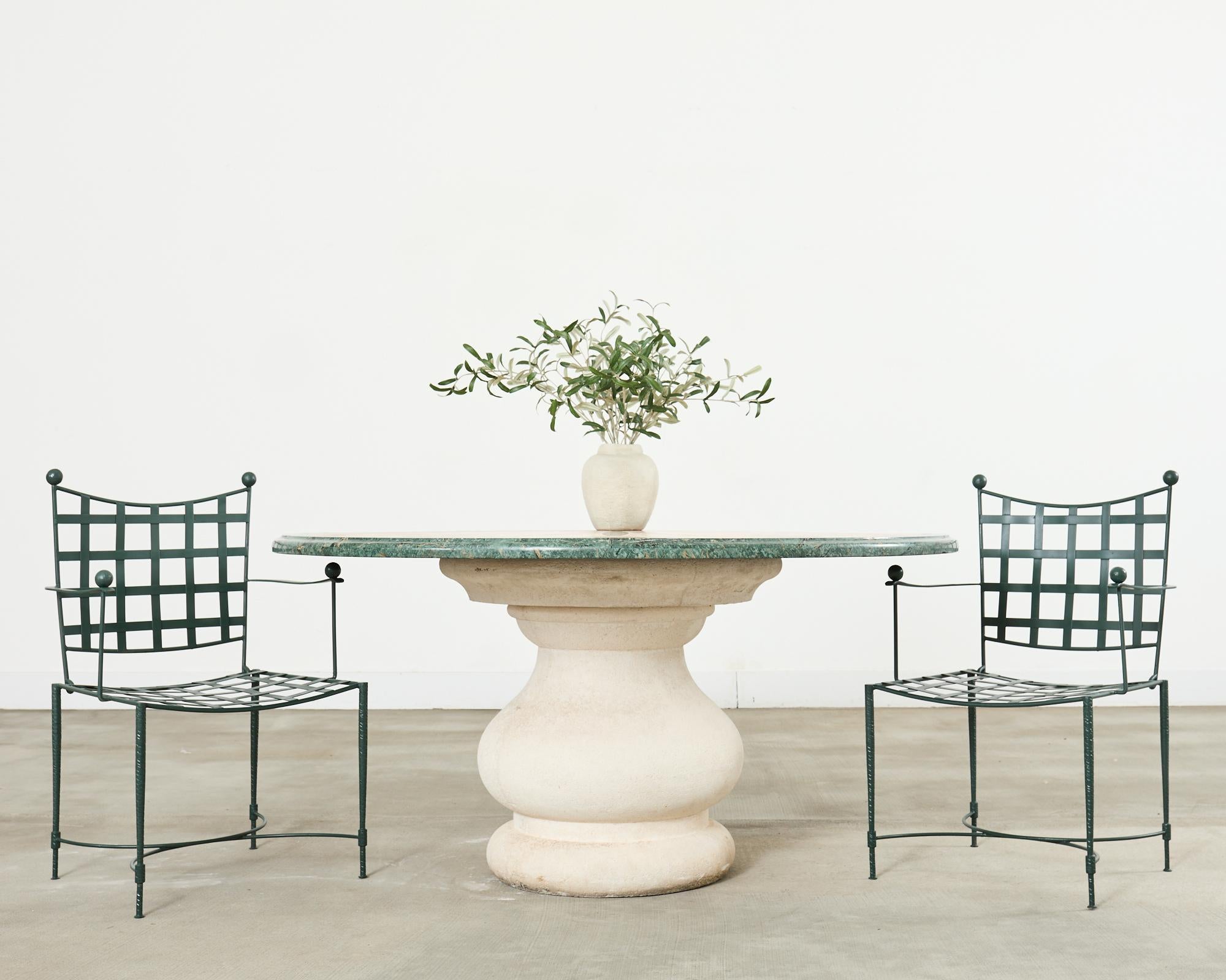 Grand Italian neoclassical style center table or garden dining table featuring a marble inlay top in the pietra dura style. The top is 1.5 inches thick with decorative ogee edge. The inlay pattern features large scrolls centered by a star shape. The