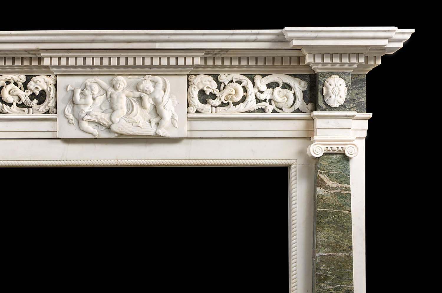 A large and imposing statuary and Connemara marble neoclassical style chimneypiece made in the Palladian manner. The wide stepped shelf rests above a band of substantial dentil carving, beneath which lies a Connemara marble frieze centred with a