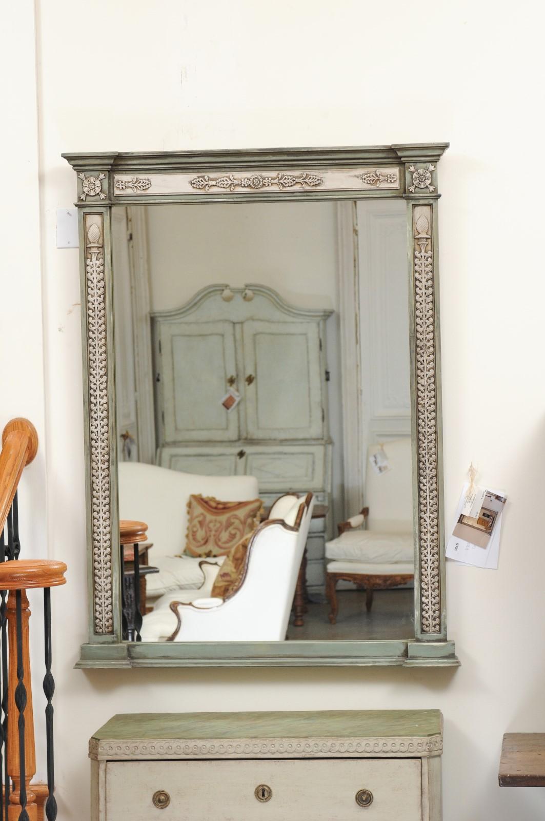 A tall painted wood mirror made from mid-18th century French door frames with carved motifs, priced and sold separately. This mirror features an exquisite linear frame, made from French 1750s doors. This general linearity reminds us of the new