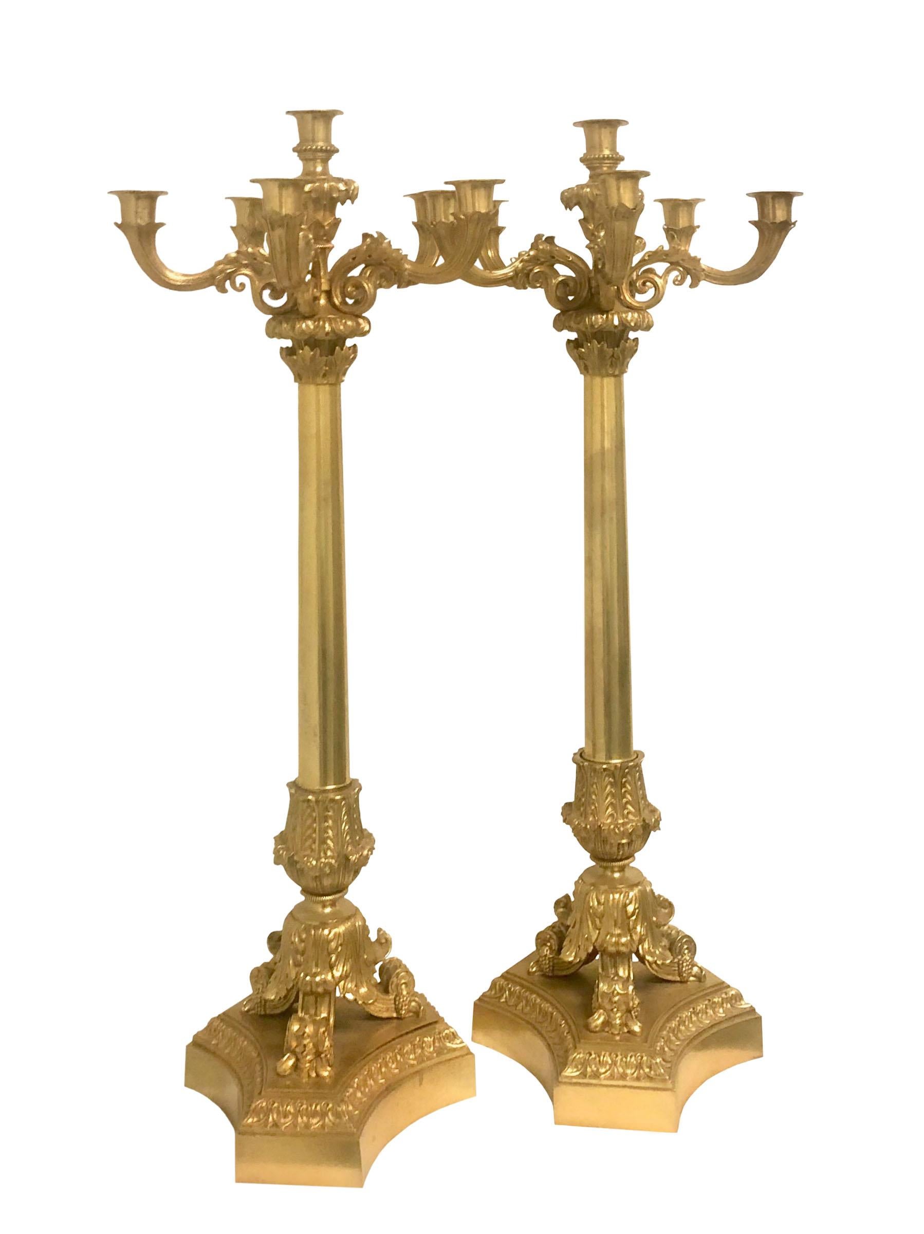 A pair of splendid 19th century neoclassical style bronze ormolu candelabra by Picard. These would make the perfect addition to any holiday table or mantle.
