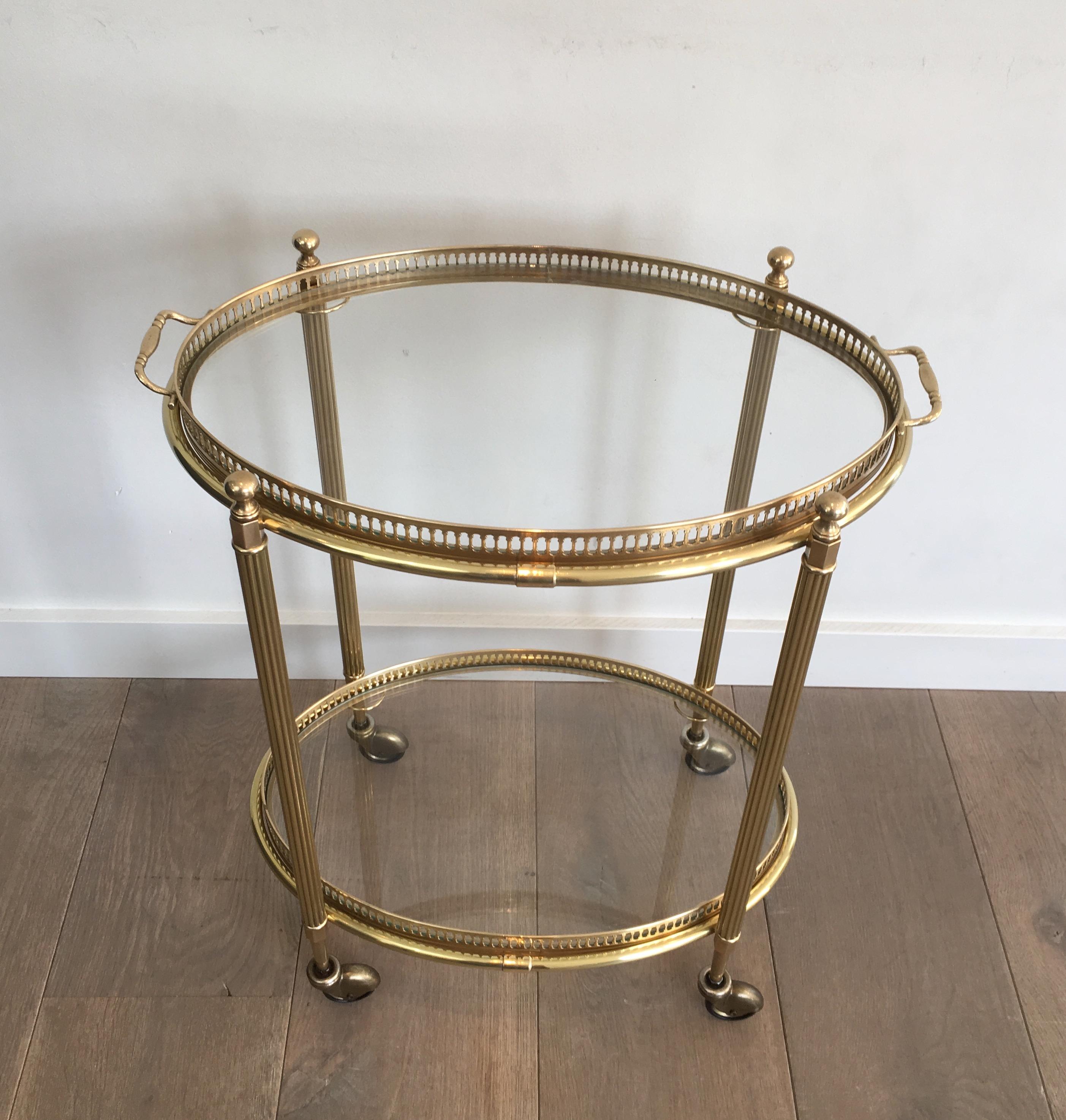 This neoclassical style oval bar cart is made of brass with removable trays. This is a French work, circa 1940.