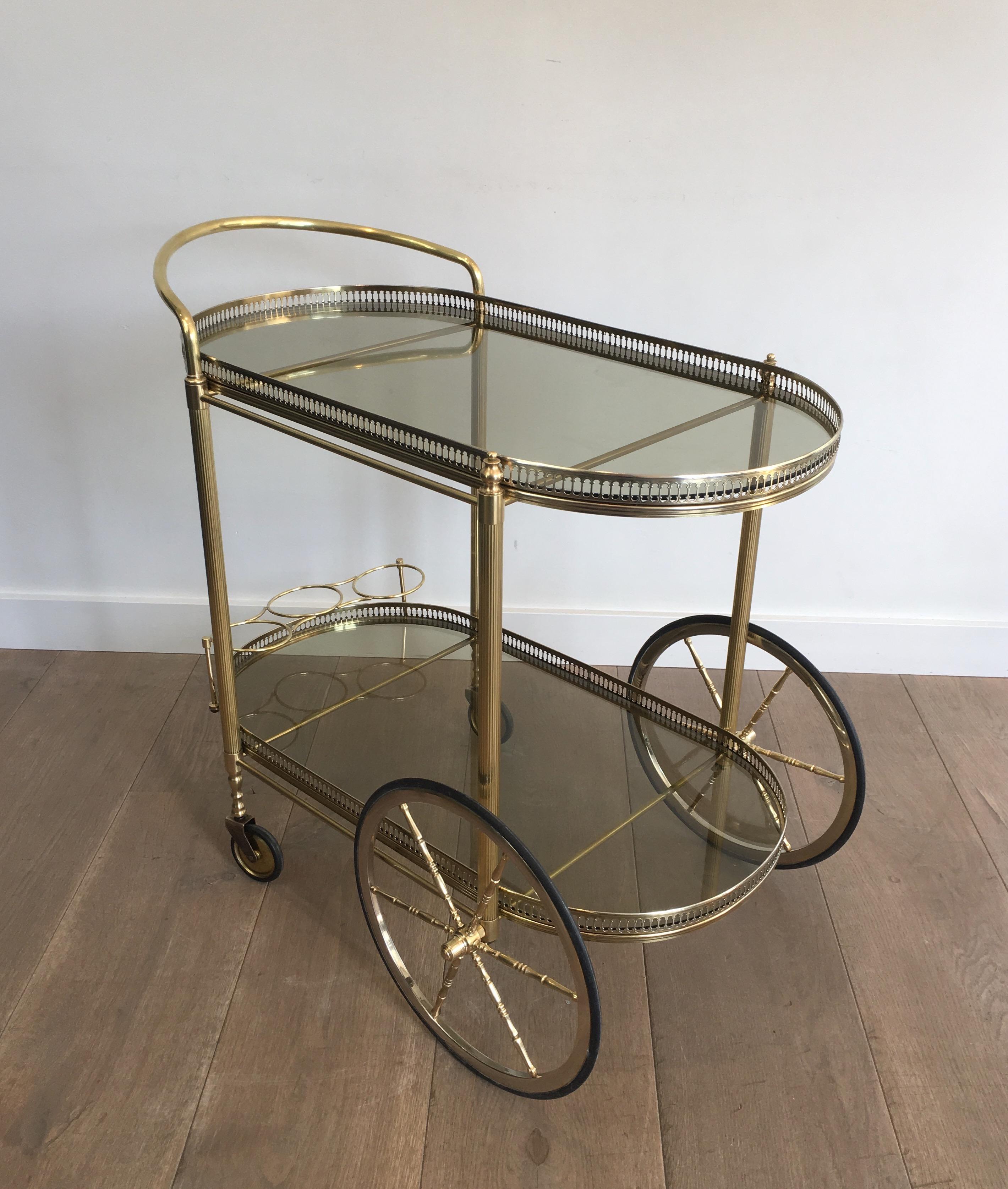 Neoclassical Style Oval Brass and Gilt Bar Cart with Greenish Smoked Glass 11