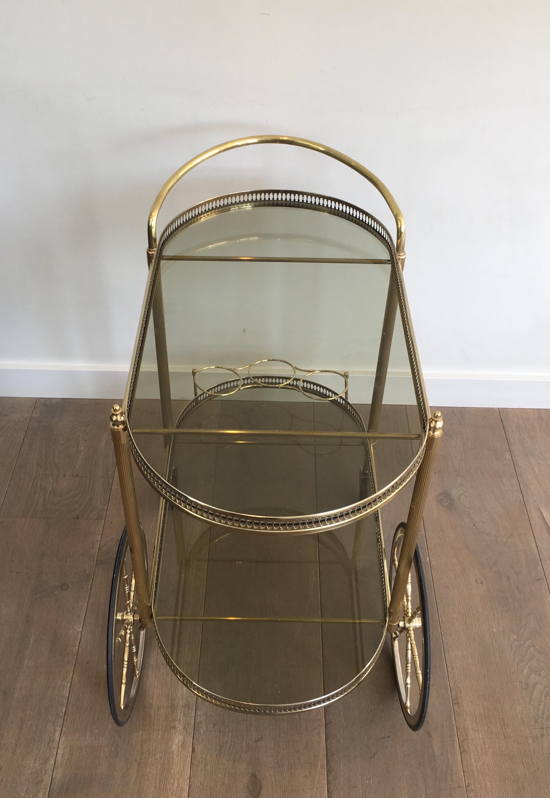 Neoclassical Style Oval Brass and Gilt Bar Cart with Greenish Smoked Glass 3