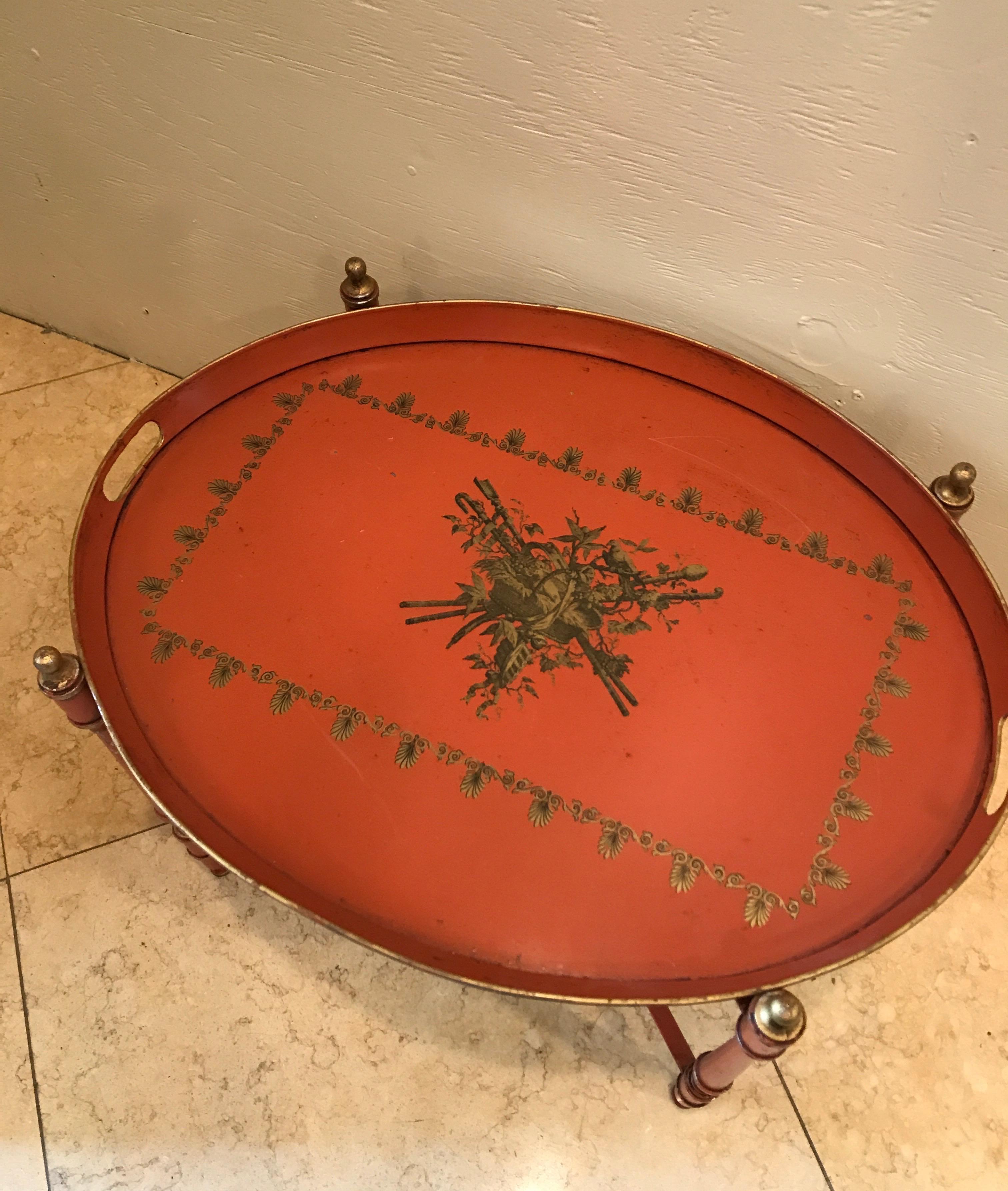 Oval tole tray on stand in a French neoclassical motif.