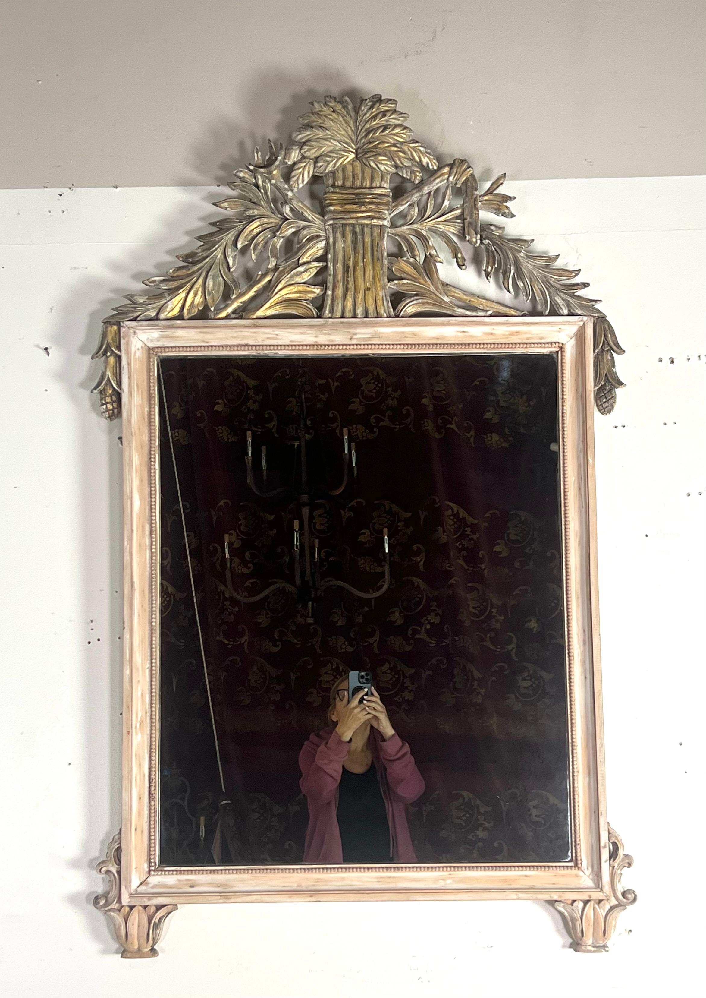 Italian neoclassical style mirror with rustic elements.  The frame is painted in a distressed, light colored finish, giving it a weathered appearance.  It features a thin, beaded border around the edges for added detailing.

The highlight of the