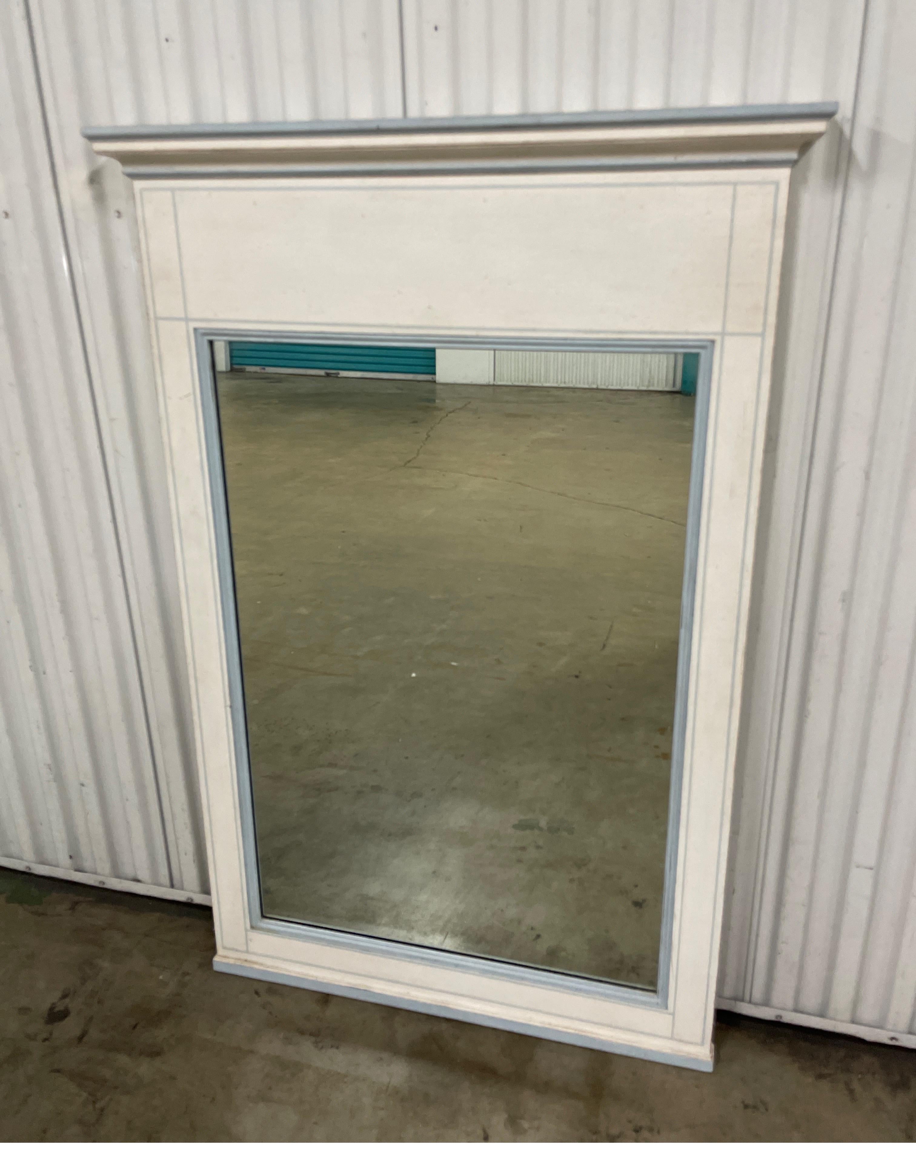 Neoclassical style painted trumeau mirror by John Widdicomb. It is painted in white with pale blue trim. Simple & elegant.