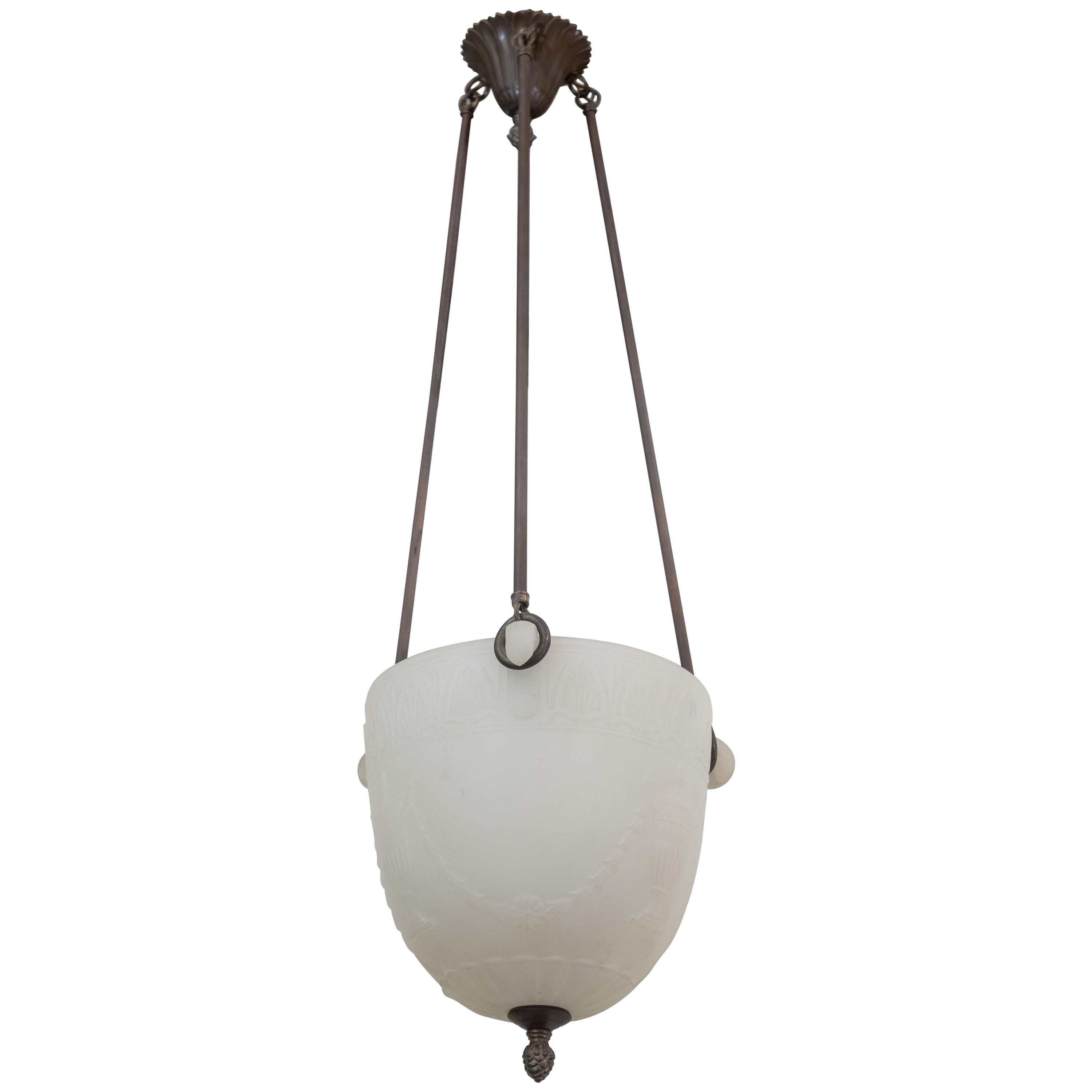 This unusual and diminutive glass pendant is a hard to find size. Having little handles and nice design pressed into the glass make this one a great choice for an entryway, hallway, bedroom and any other place. Can easily be shortened if need be.