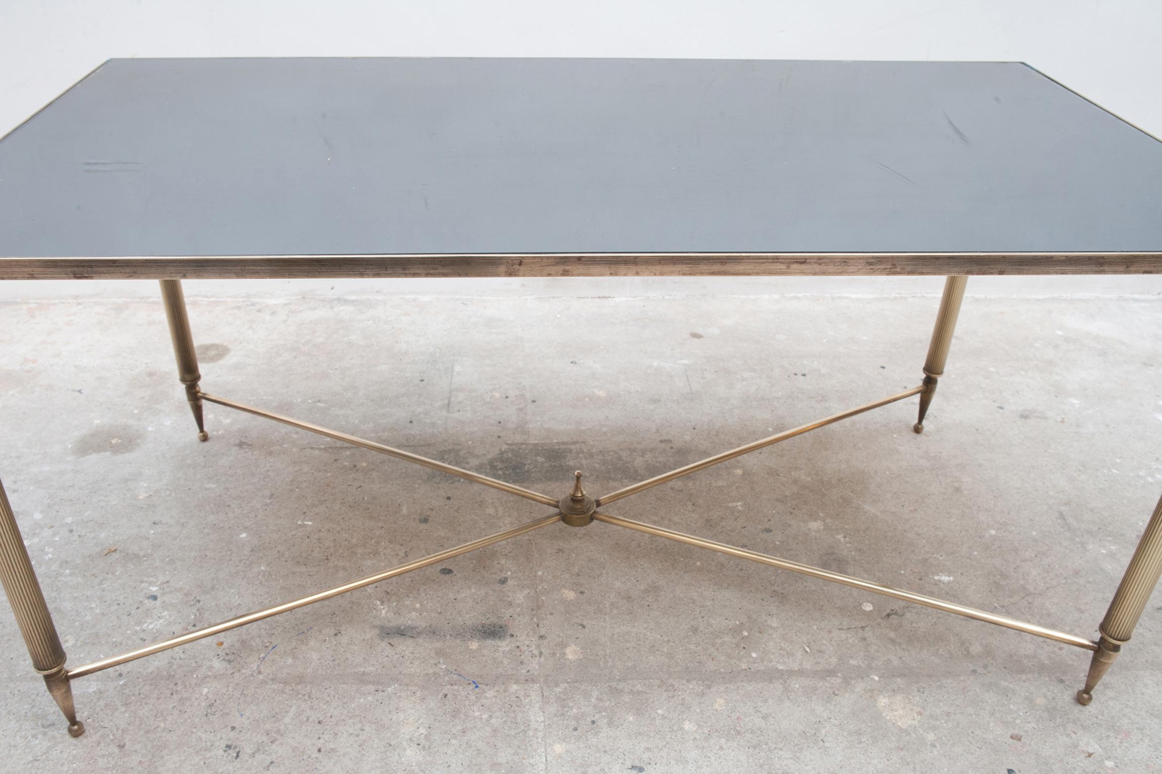 Neoclassical style rectangular brass coffee table by Maison Baguès. The brass legs are joined by a brass stretcher. 

An elegant and timeless piece to go with any style decor, modern, midcentury or traditional.