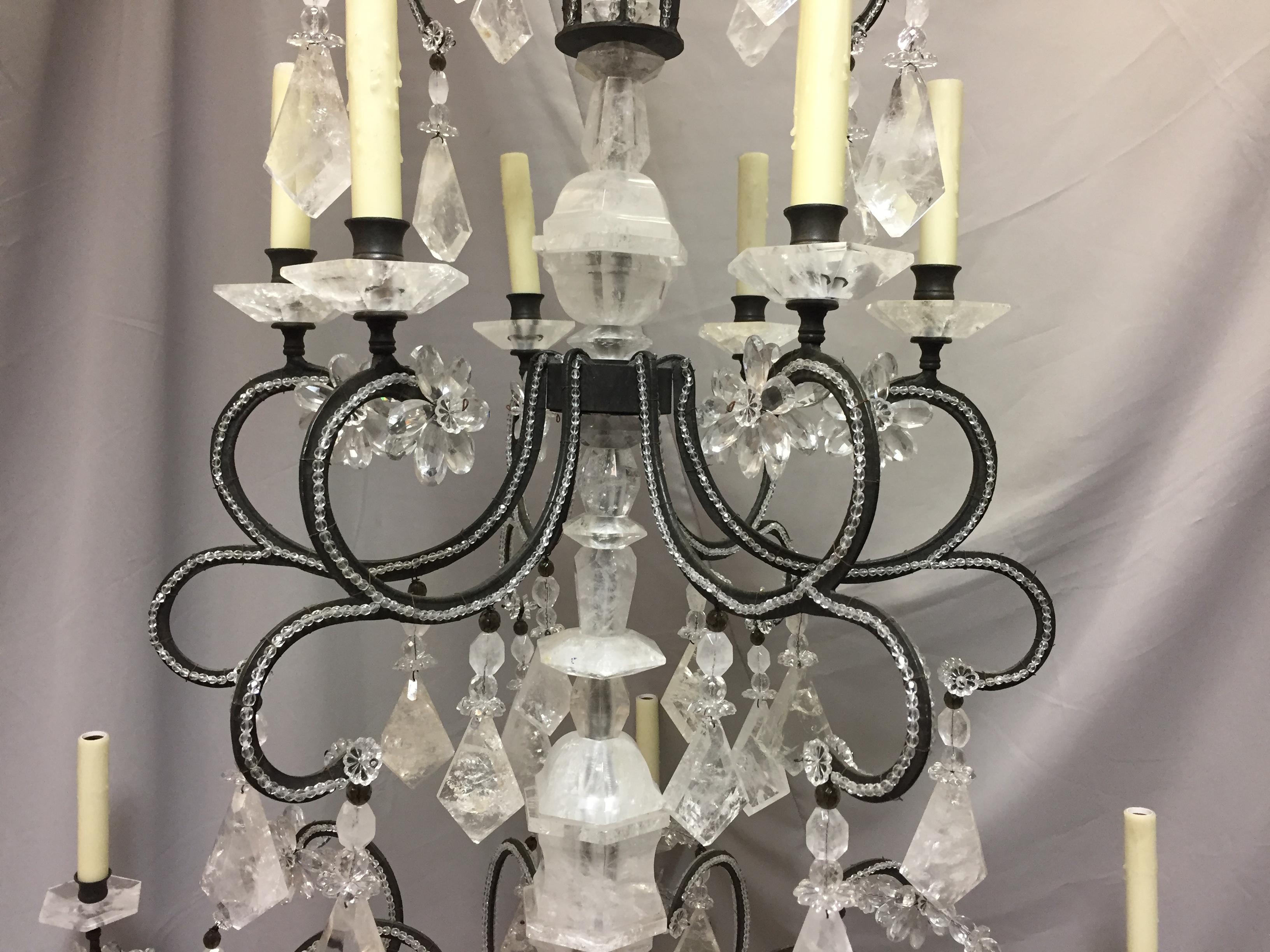 Outstanding and elegant neoclassical style hand forged wrought iron 12-light chandelier, dressed with hand carved and hand polished fine rock crystal prisms, all arms are beautifully beaded.
Also enhanced with rock crystal Bobesches. Meticulous