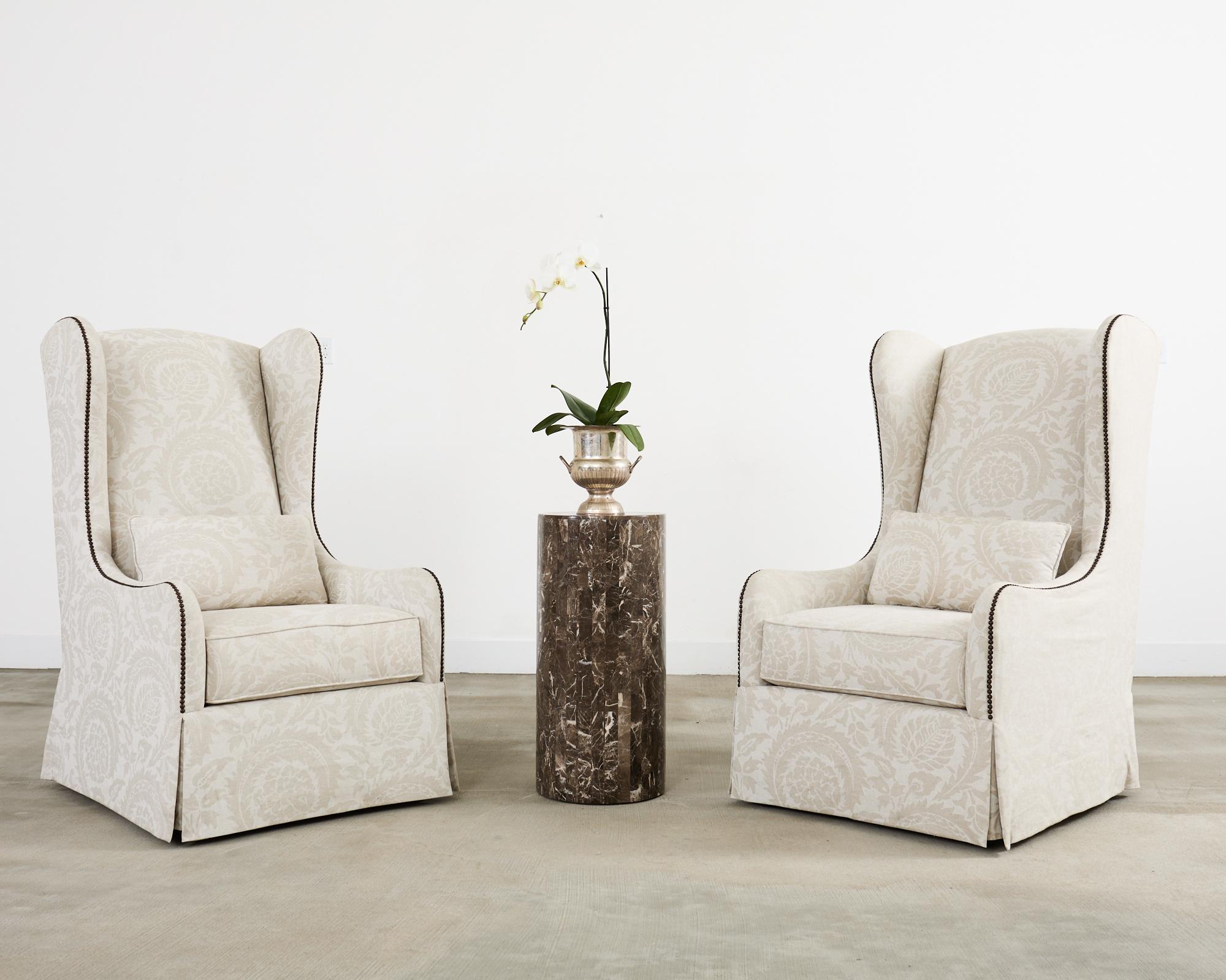 Opulent round column pedestal display table crafted from variegated marble stone veneer in the neoclassical style. The pedestal was used to display sculpture and has a flat top. The outside of the stand has smooth and polished seams in a geometric