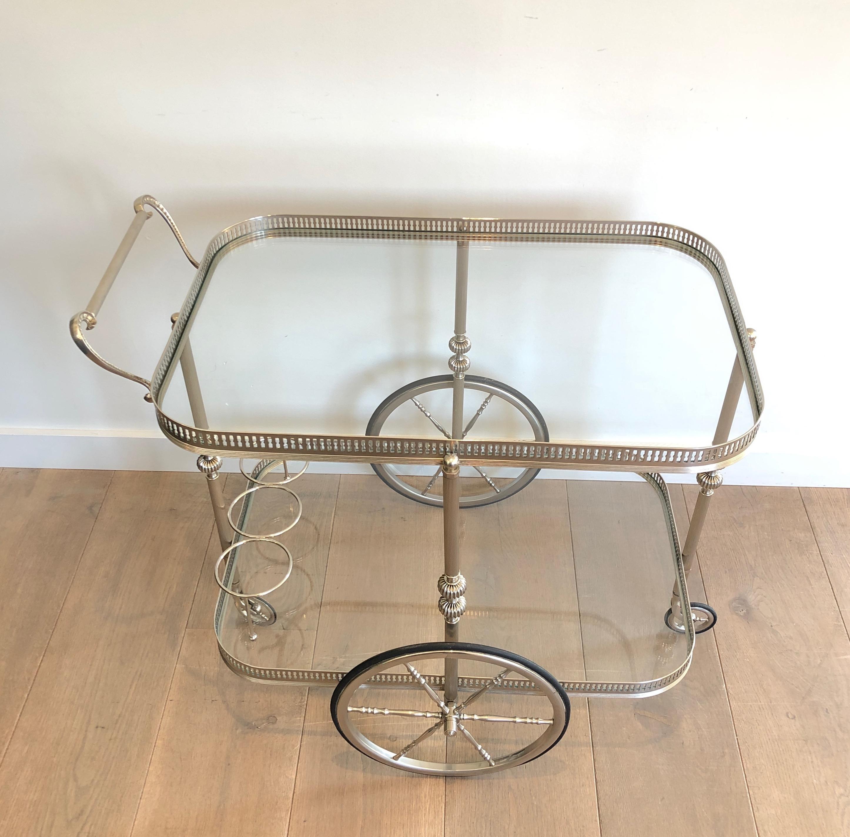 This neoclassical style bar cart is all made of silvered brass. This is a French work, in the style of Maison Jansen, circa 1940.
