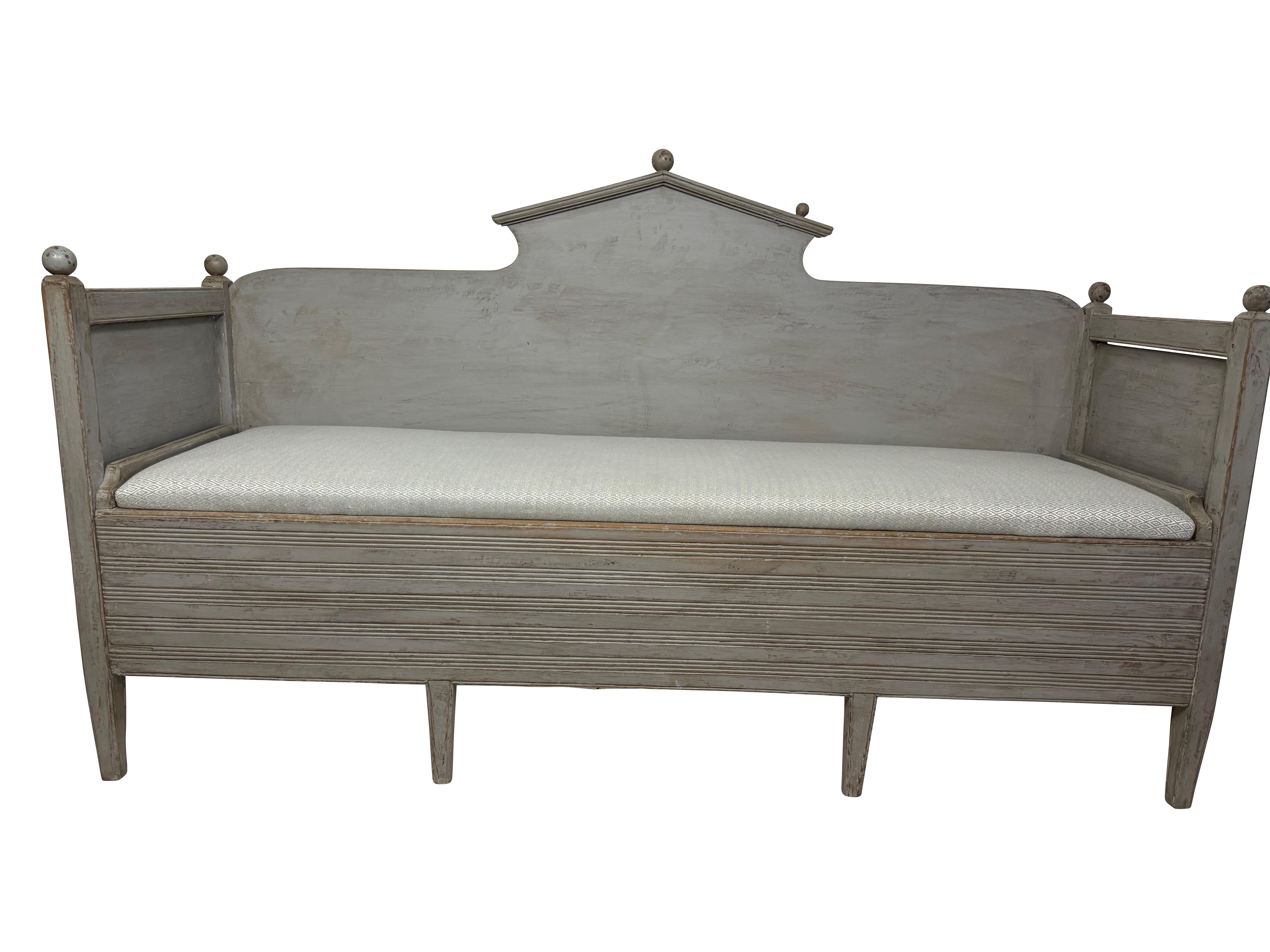 Classic Swedish Gustavian grey-painted hand-carved bench/ sofa with storage. One missing ball finial has been replaced and painted to match.  Sorry, not in the photos.  Simple Swedish design great for a kitchen or foyer bench and to display pillows.
