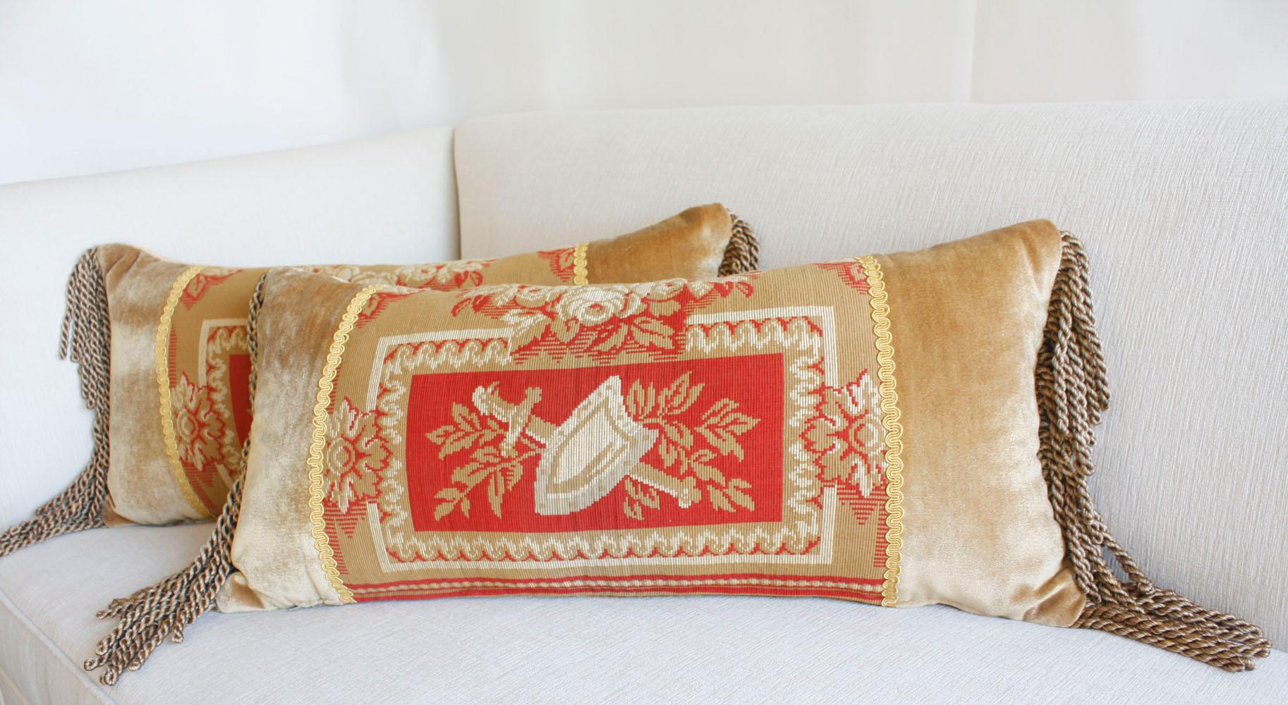 Discover the allure of our Neoclassical-style pillow pair, each featuring a beautifully detailed tapestry at the center. The tapestry depicts a classic motif of a shield and sword, set against a backdrop of intricate leaves, and encircled by vibrant
