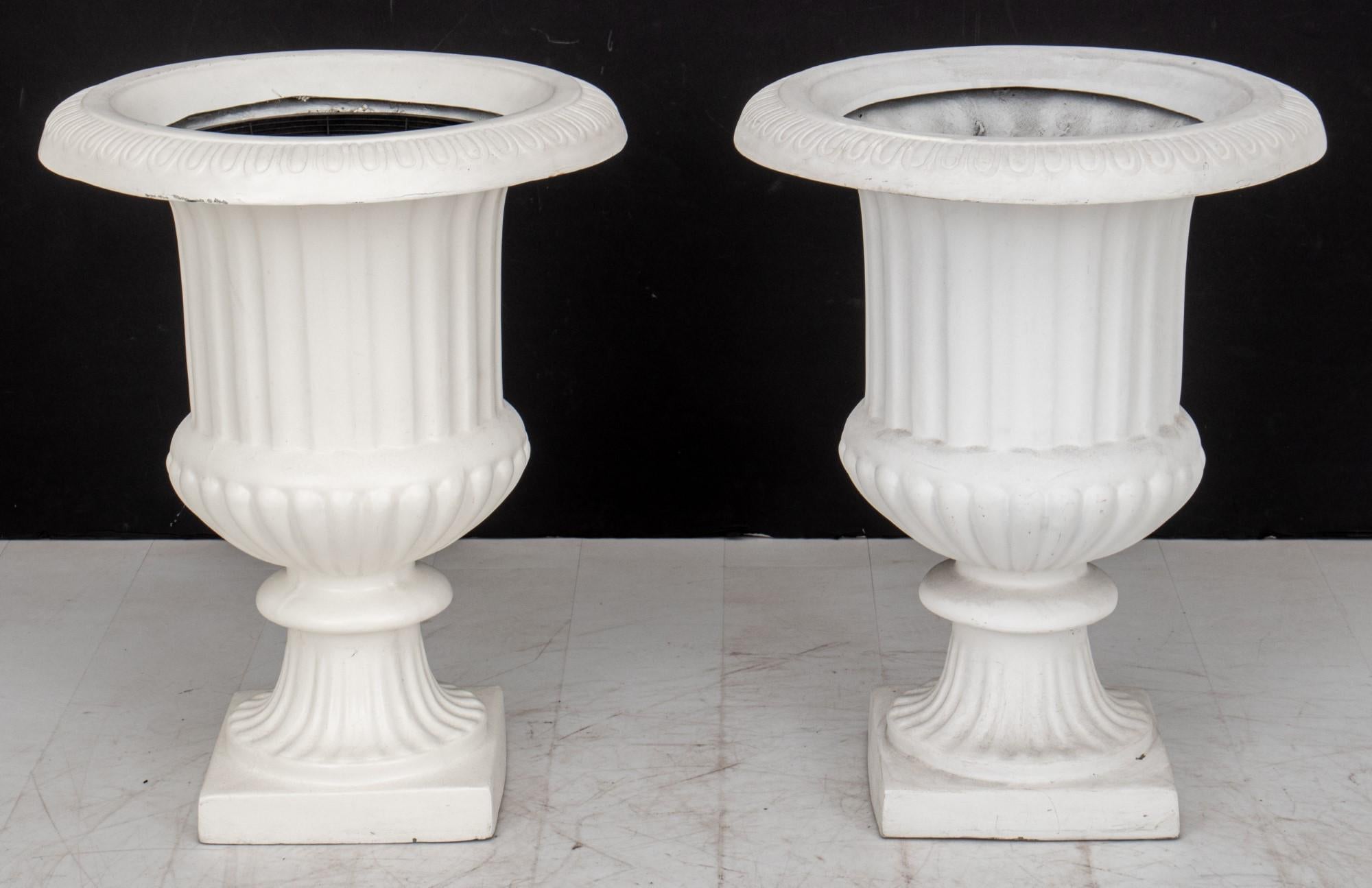 Pair of Neoclassical Style White Composite Urn Form Planters

Design: Neoclassical style urn form planters.

Dimensions: 29