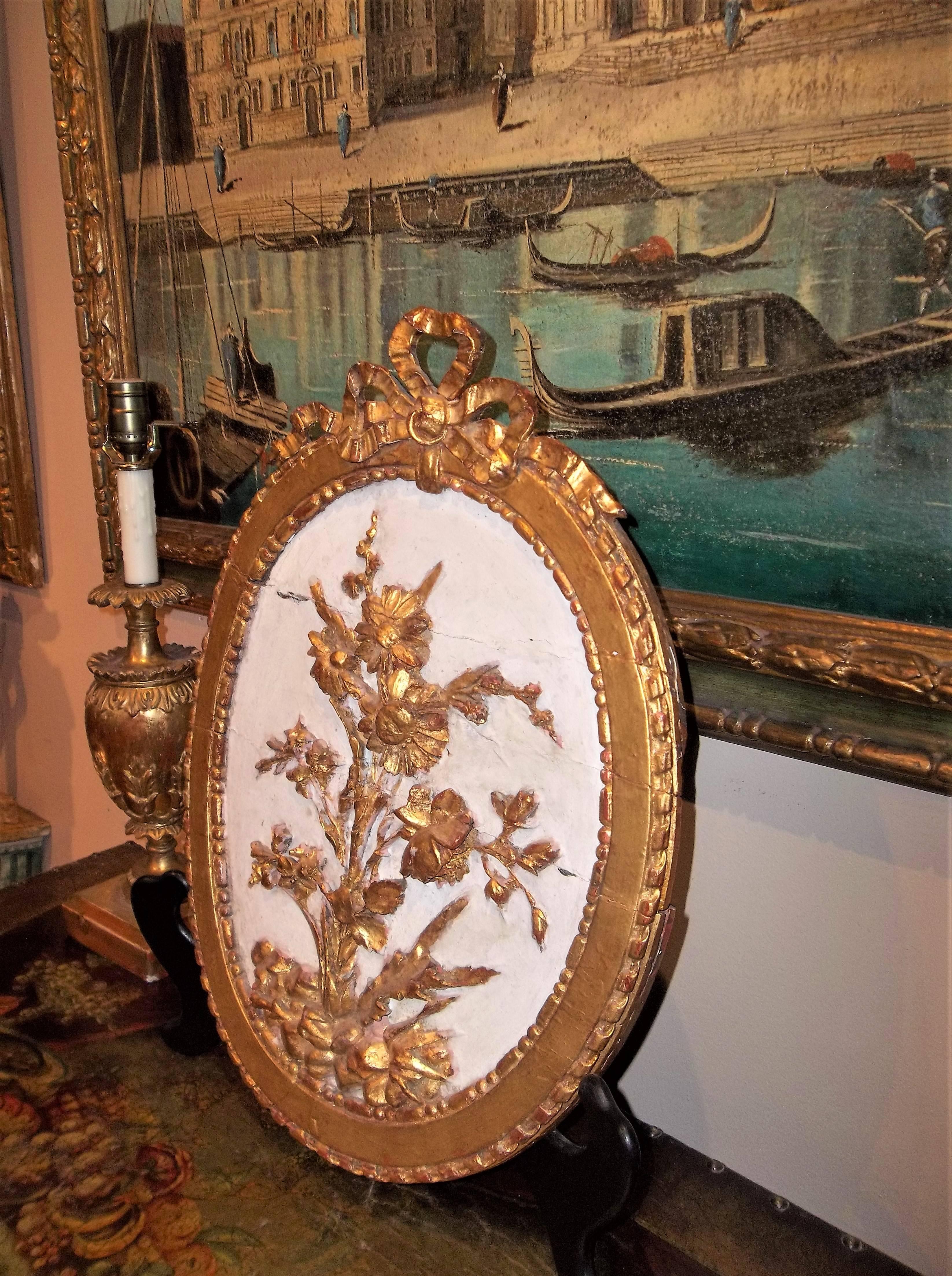 Carved and gilded floral display against crème ground, Venice, circa 1840. Oak under paint. Typical minor losses to carving and to the gilding. Red bole showing and running throughout.

Decoration refreshed .