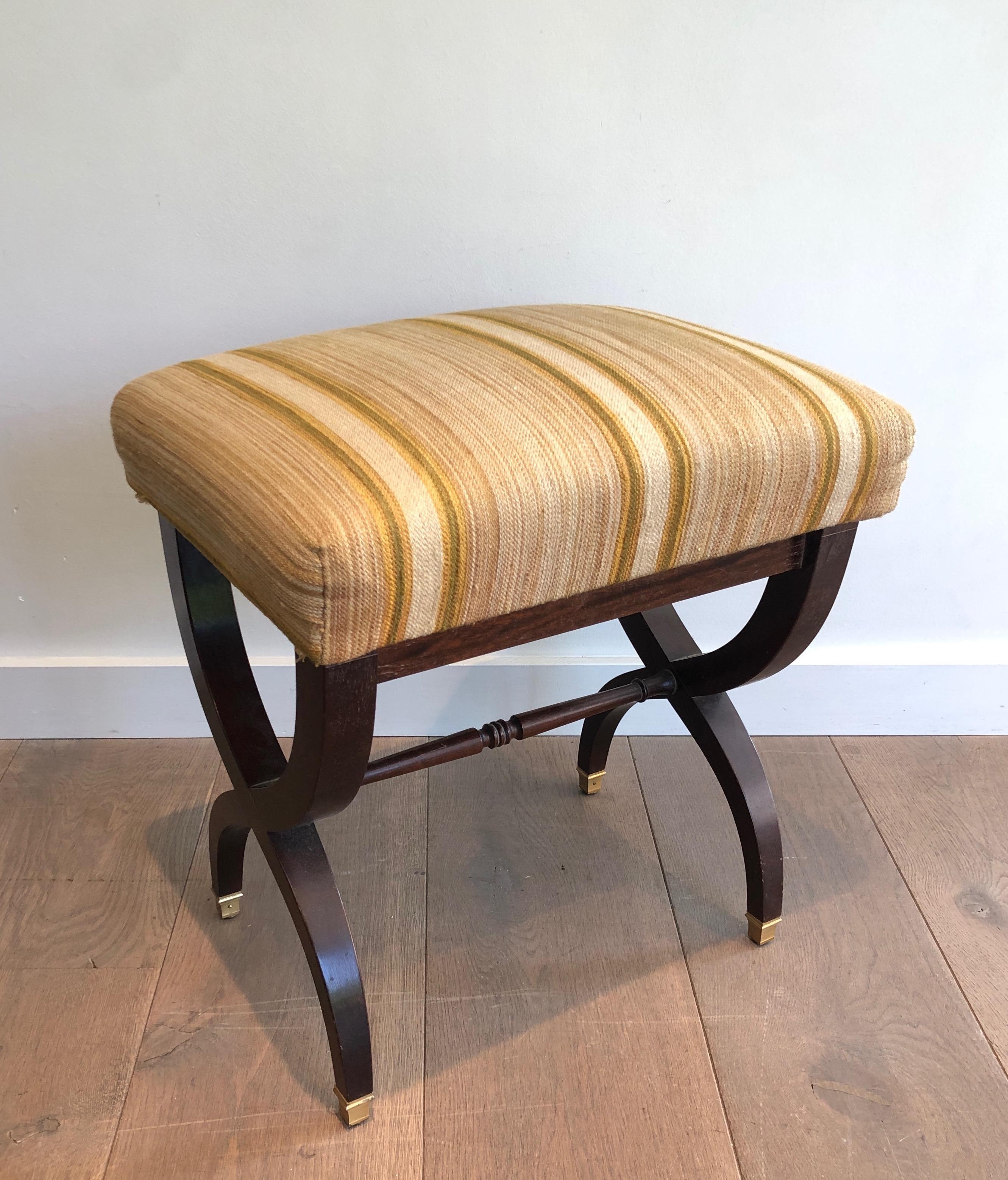 This neoclassical-style stool is made of wood with fabric on top. This is a French work. Circa 1940.
 