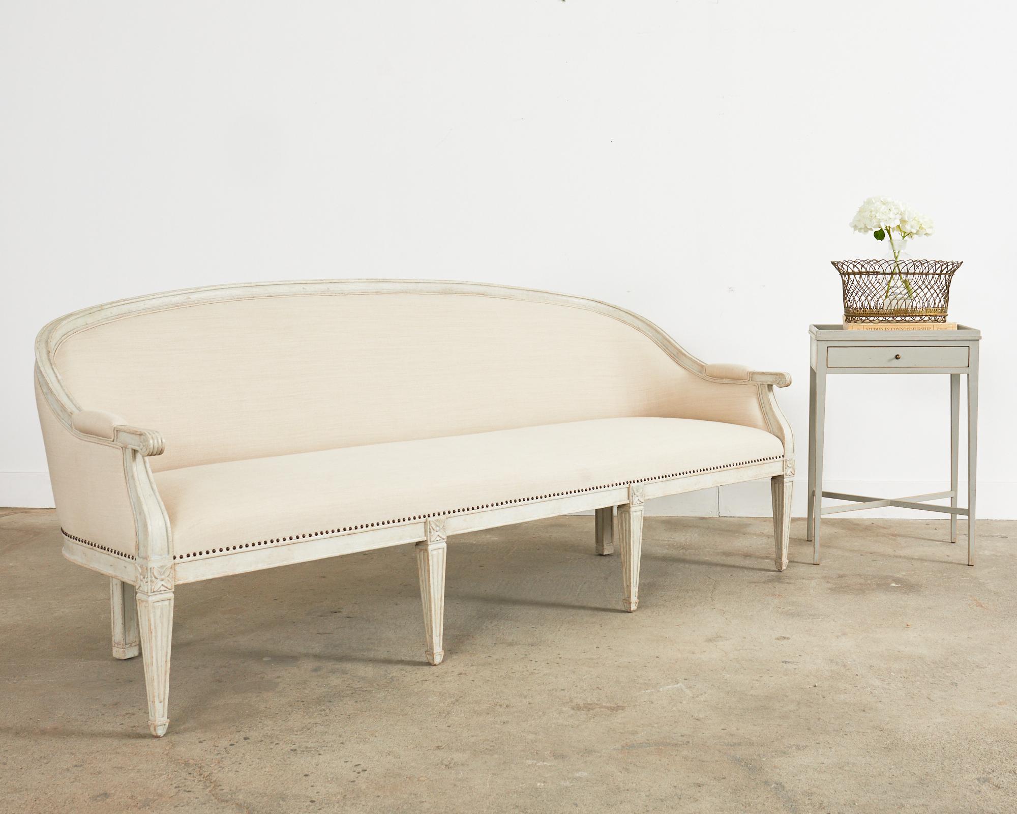 Sublime bespoke cabriole sofa, settee, or canapé made in the neoclassical Swedish Gustavian style. The sofa feature a gracefully curved cabriole style hardwood frame with an intentionally aged, distressed lacquer painted finish. Upholstered with a