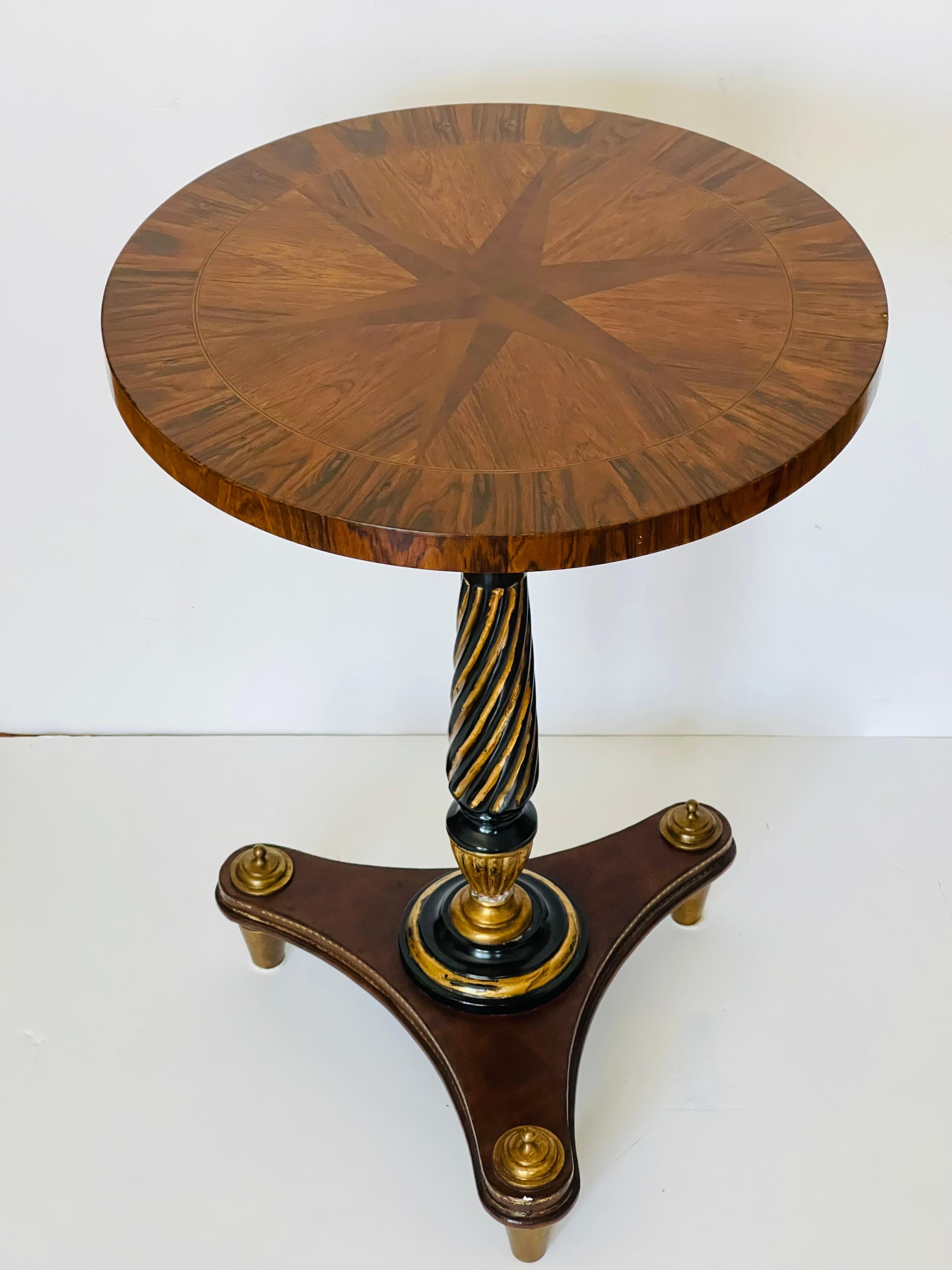 Neoclassical Revival round pedestal side table with two wood star inlay. 