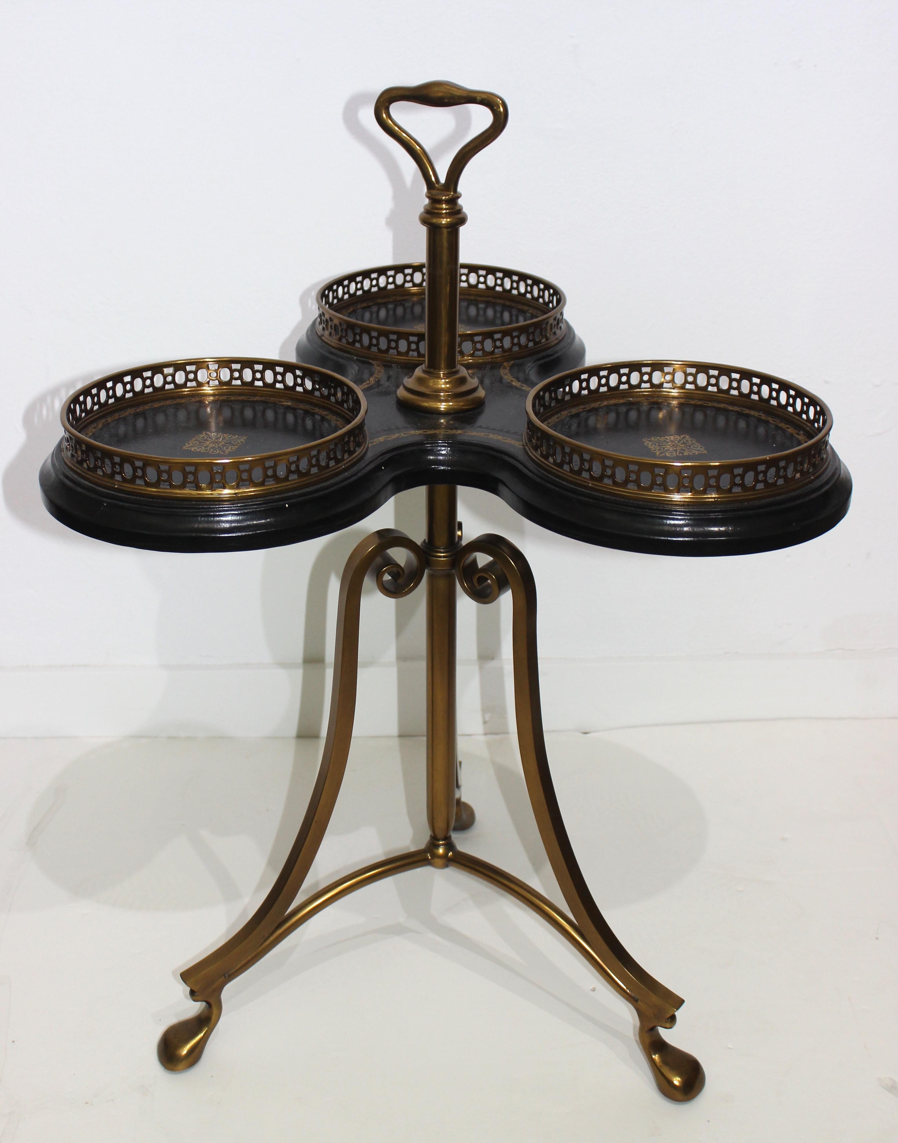 This stylish trefoil form table dates to the 1980s-1990s and was produced for La Barge furniture company. The piece is fabricated in cast bronze and tooled leather. 

Note: The round gallery sections measure 8.50