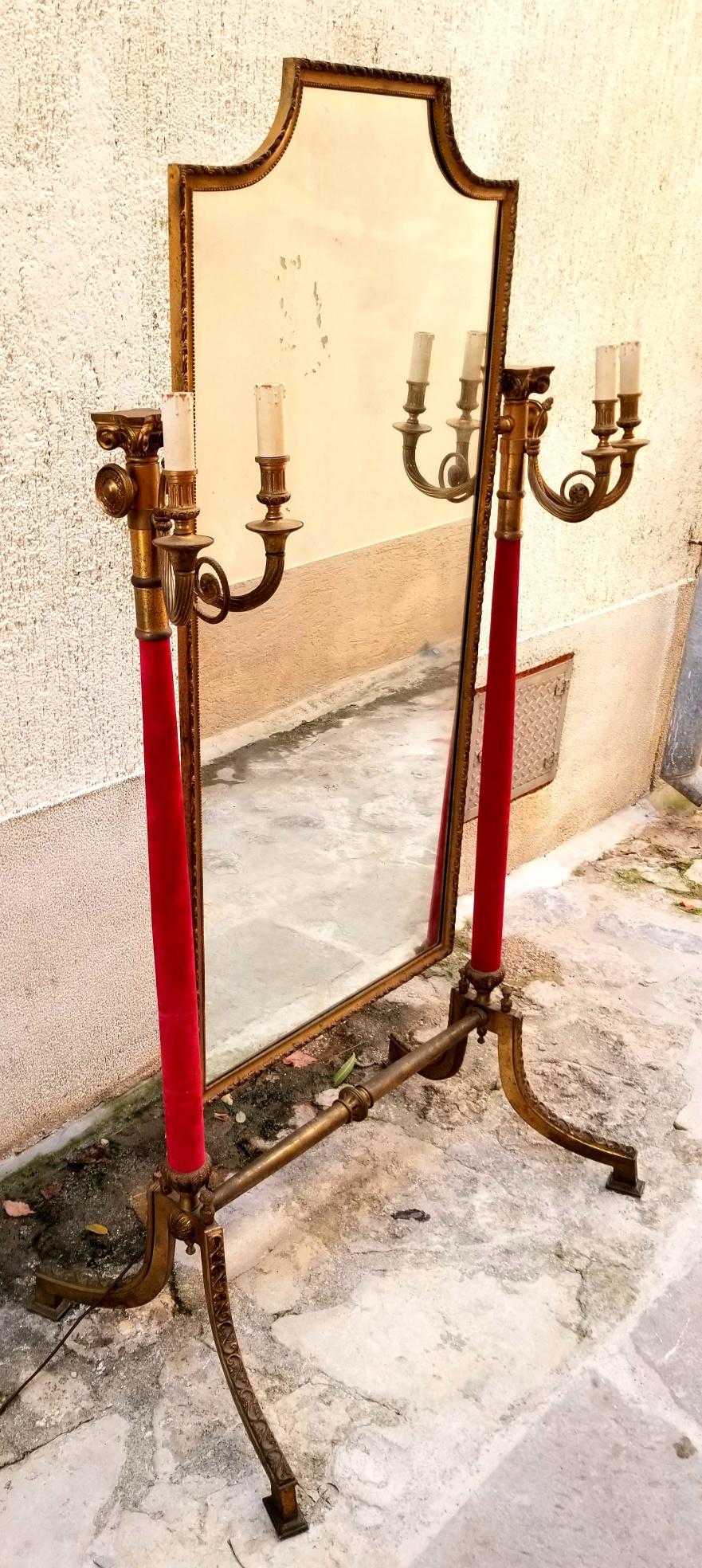 Italian brass mirror from Venice boutique at San Marco square. Mirror is a full size length and adjustable like a chevalier mirror. The mirror itself is 53 height and 25 width. The candle cover is hand carved wood and the rest is brass. The red