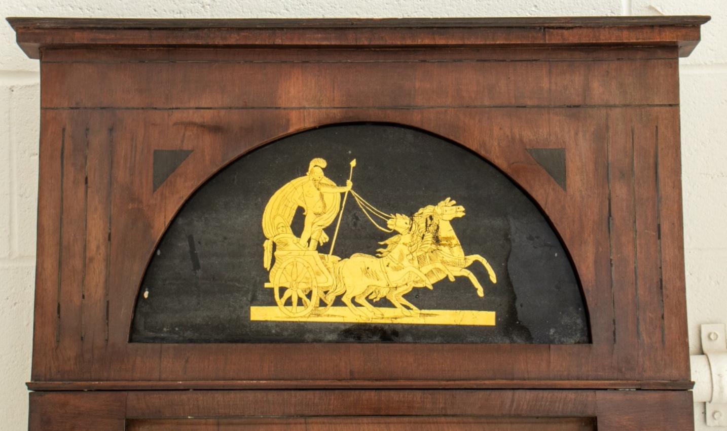 Neoclassical reverse painted glass or verre eglomise mounted mahogany mirror, 19th century, possibly North German, vertical rectangular form with cornice, the reverse painted transom depicting a warrior in his chariot in gold on black ground above a