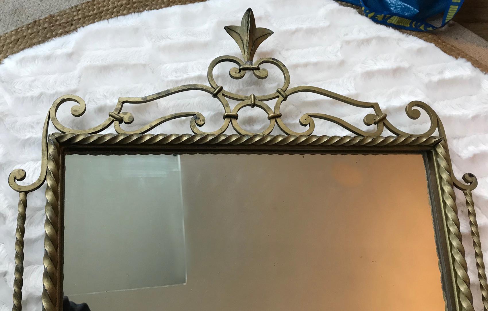 Elegant neoclassical style wall mirror in matte gilt wrought iron and wood on the back.
France, 1950.
In a good general condition.
