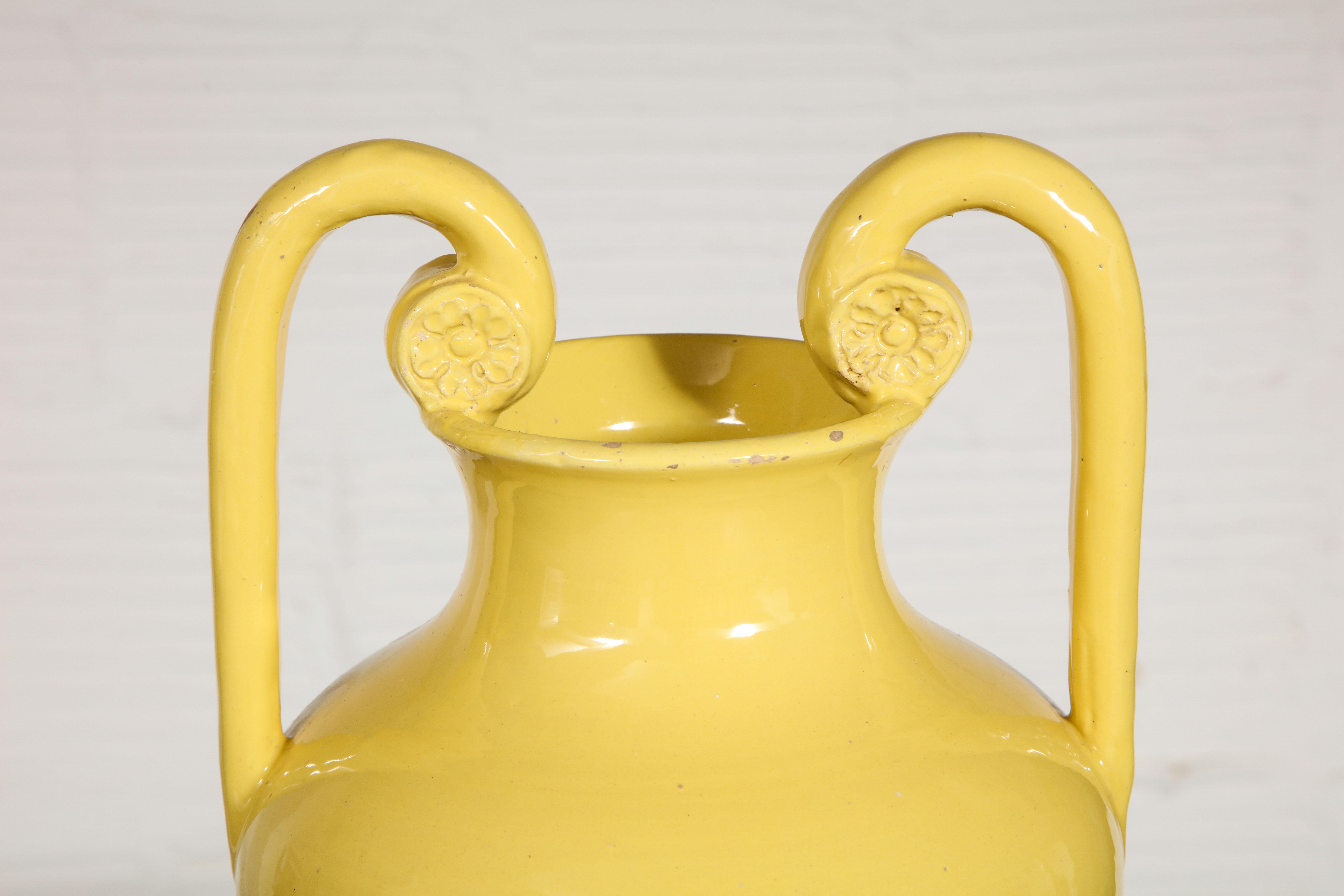 Earthenware vase of neoclassical form glazed a striking yellow. Marked Italia to underside.