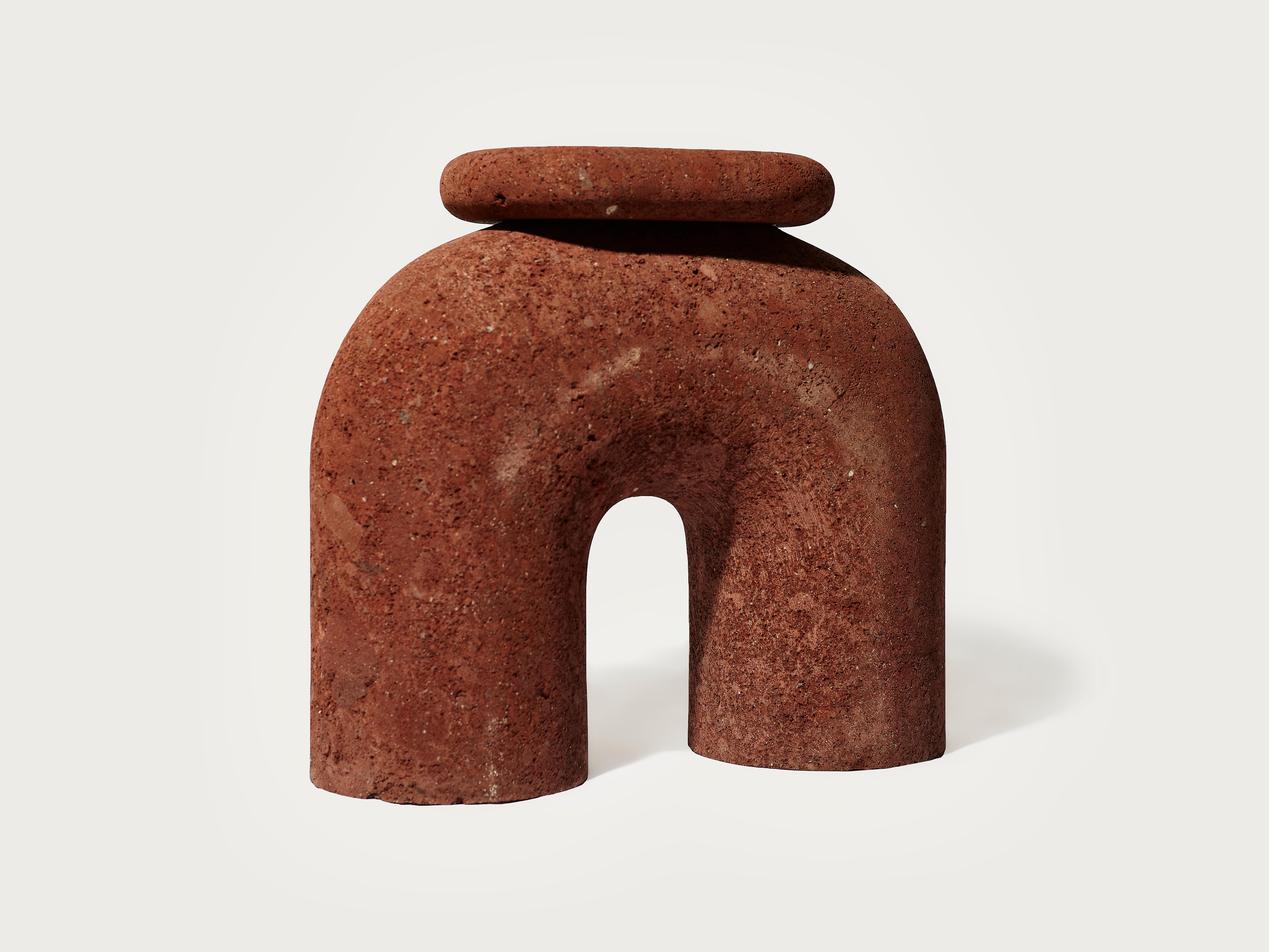 El Pensador Neolítico es un taburete esculpido a mano en piedra roja de tezontle, una roca volcánica muy oxidada y porosa endémica de México. Su diseño bebe de diferentes referencias históricas que confluyen en una forma sincrética que es a la vez