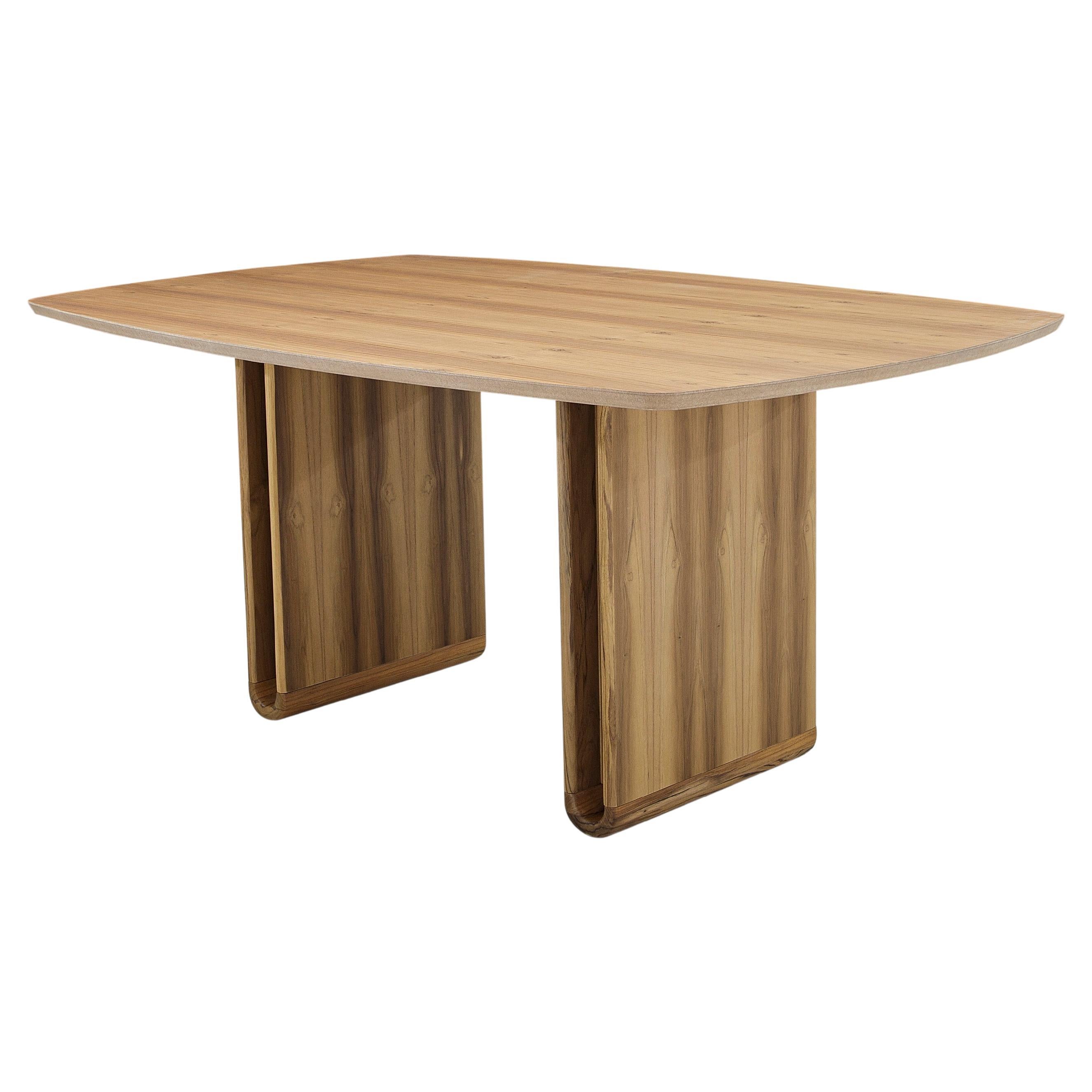 The refined shapes of the Neon dining table in teak make it a uniquely shaped addition to your dining room. It is a sophisticated table for a modern contemporary or minimalist decor with symmetrical proportions along with the curved detail of the