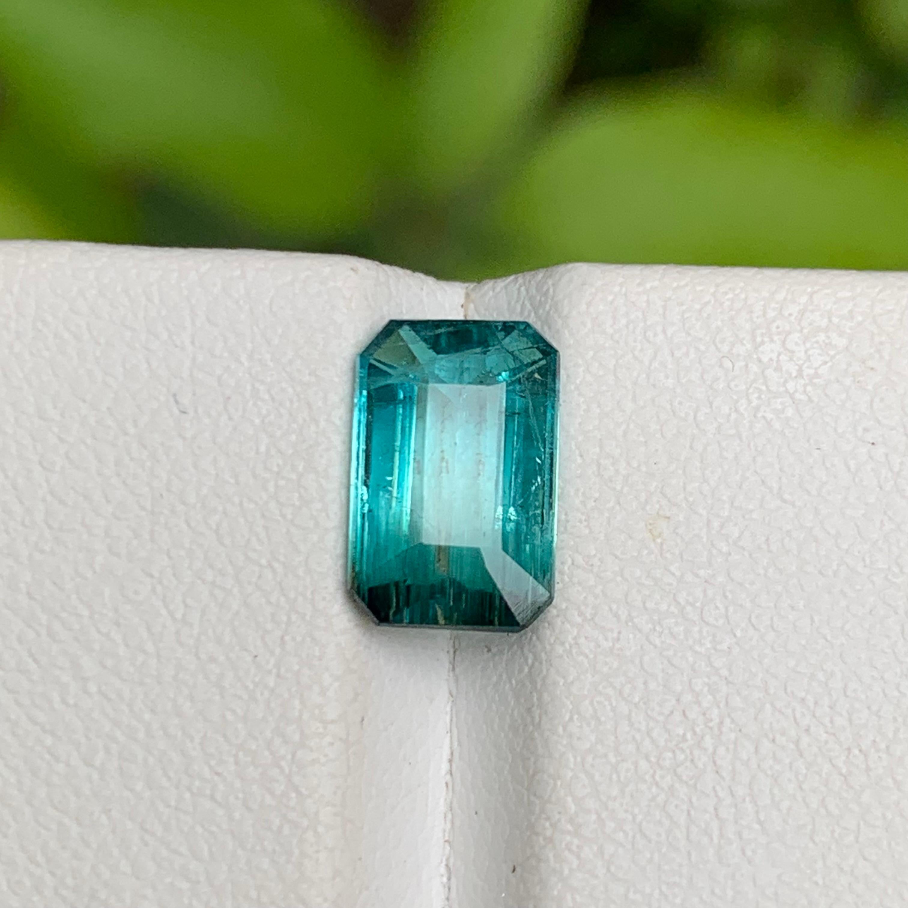 💎 GEMSTONE TYPE: Tourmaline
⚖️ WEIGHT: 2.60 Carats
🪚 SHAPE & CUT: Emerald Cut
📏 SIZE (MM): 10.50 x 6.82 x 4.01
🌈 COLOR: Neon Greenish Hue Blue Bicolor
🔎 CLARITY: Slightly Included 
🧪 TREATMENT: None (100% Natural)
🌍 ORIGIN: Kunar, Afghanistan