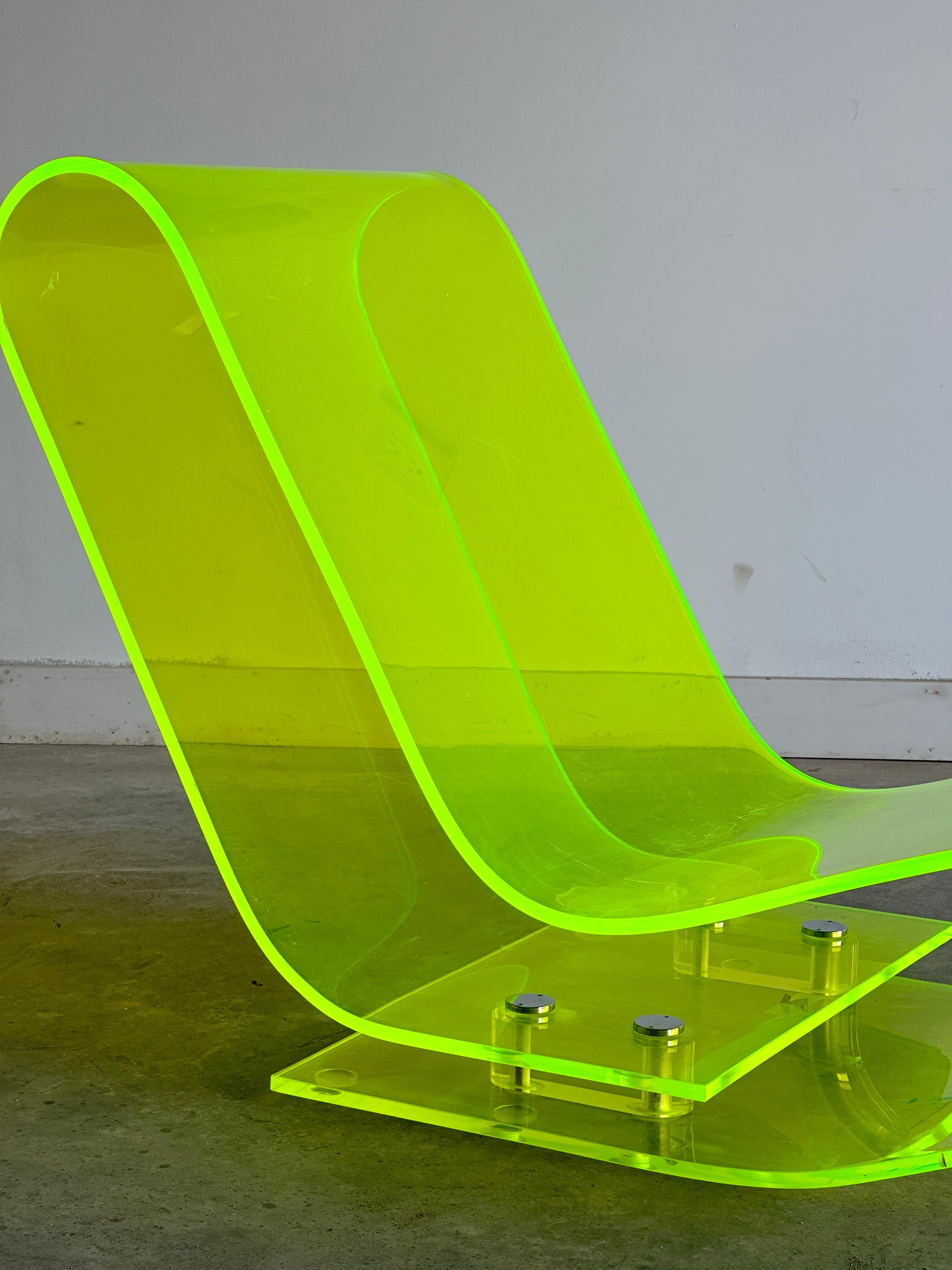 This electric green Model 6040 chair by Maarten van Severen is a stunning piece of modern design that combines functionality and aesthetics. It is made of a single sheet of transparent methacrylate that bends around itself to create an incredibly