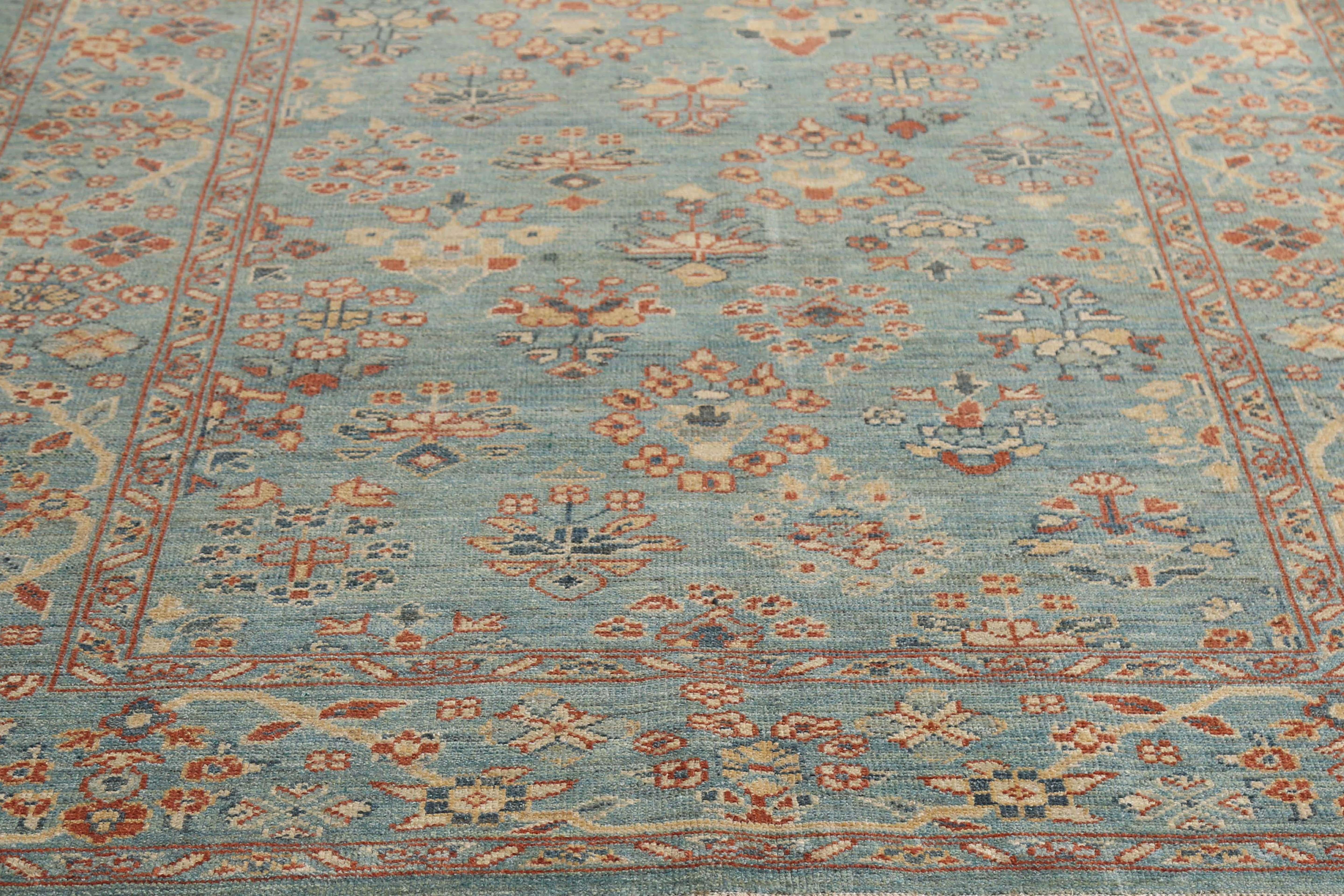 Introducing our exquisite handmade Turkish Sultanabad rug, measuring 6'0'' by 9'0''. This stunning rug boasts a beautiful blue background with intricate designs featuring light orange, blue, and navy colors. The traditional design is accentuated by