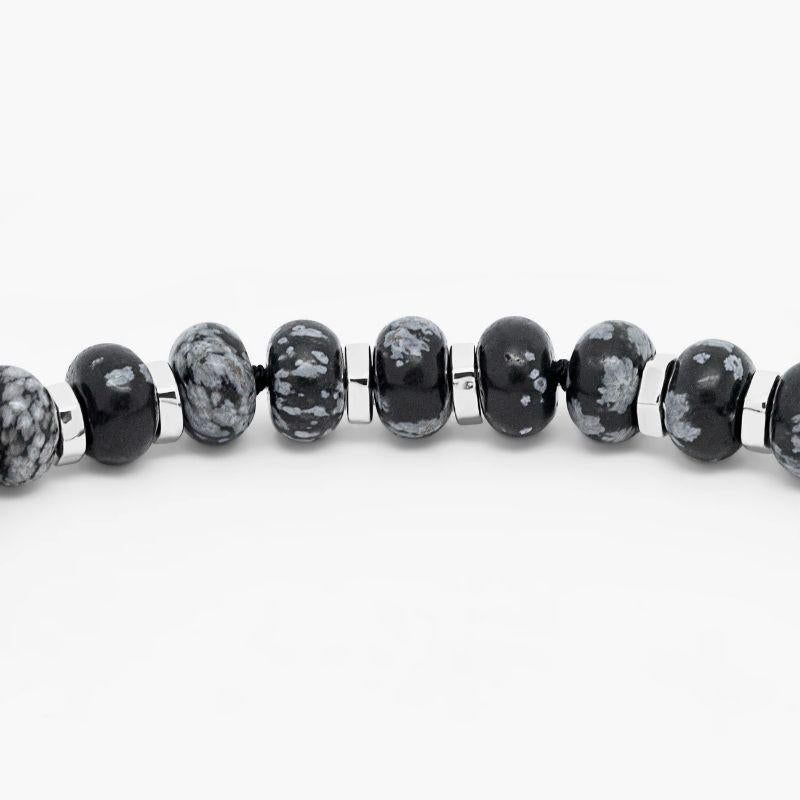 Nepal Bracelet with Black Macramé and Polished Snowflake Obsidian Beads, Size L

Monochrome snowflake obsidian beads hold rich colour, creating a unique sparkle within each stone. Rhodium plated sterling silver components compliment the silver