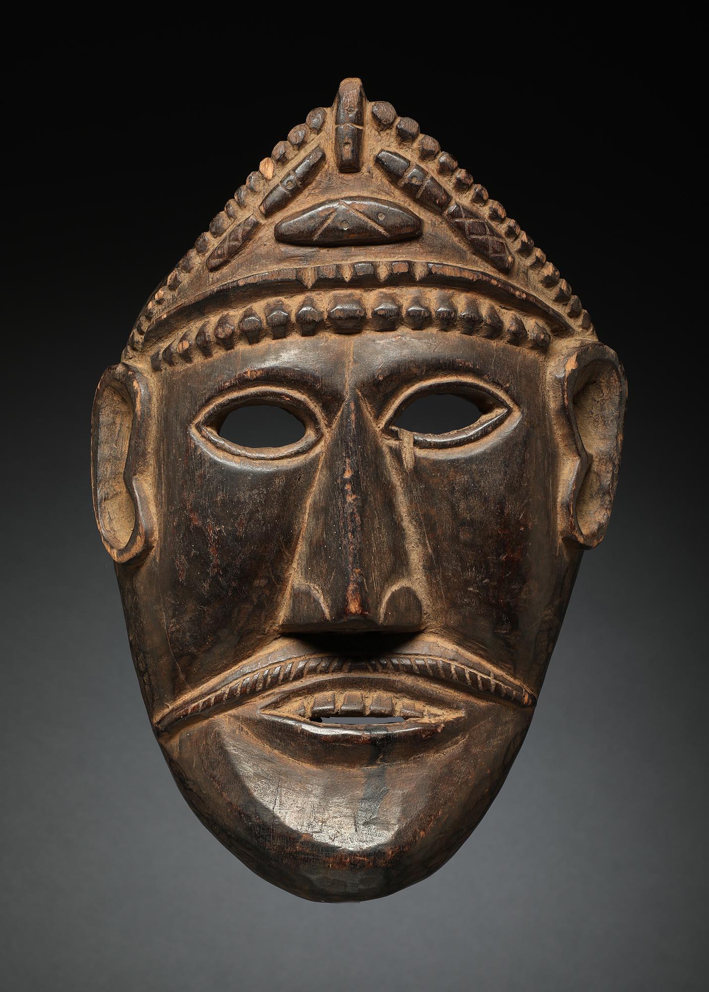 Flat dance mask from Nepal with flat face with strong chin, open eyes and carved headdress with Tzi magical beads. Ex- private collection in Midwest, ex private collection, acquired in Nepal in 1970's-1980's. Mask 12