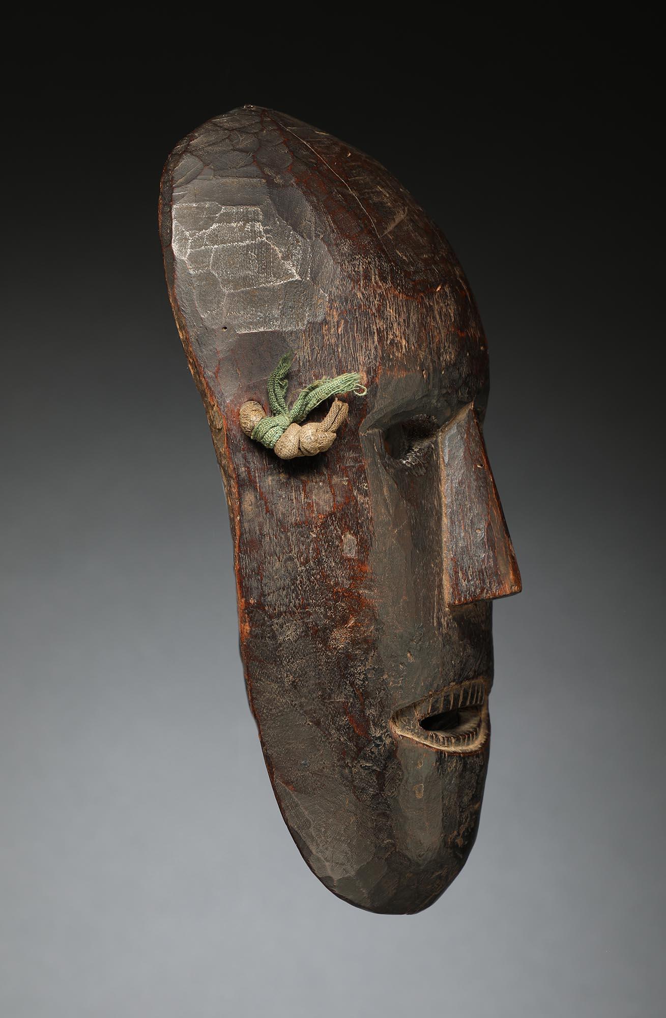 Oval dance Magar mask from Nepal with strong expression, open eyes and mouth with finely carved teeth. Heavy worn patina inside and out from traditional use. Ex- private collection in California, originally acquired from James Willis Tribal Art, San