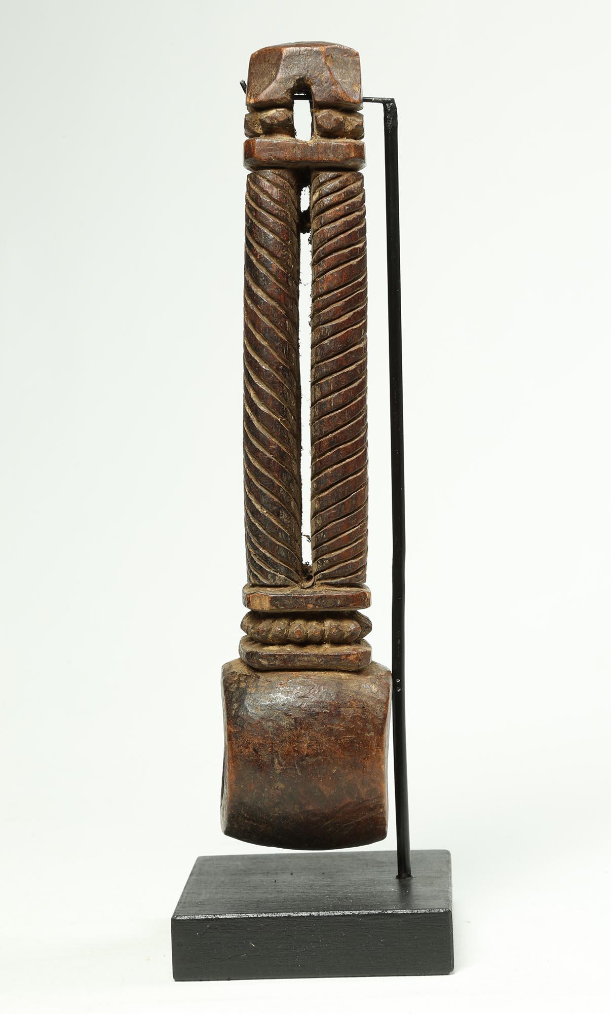 A old carved wood Nepal or Himalayan ghurra butter churn handle, Early 20th Century with four twisted columns connecting at the top. With a worn, polished patina from use, old stabile crack on custom wood and metal base. 9 1/2 inches high, on base