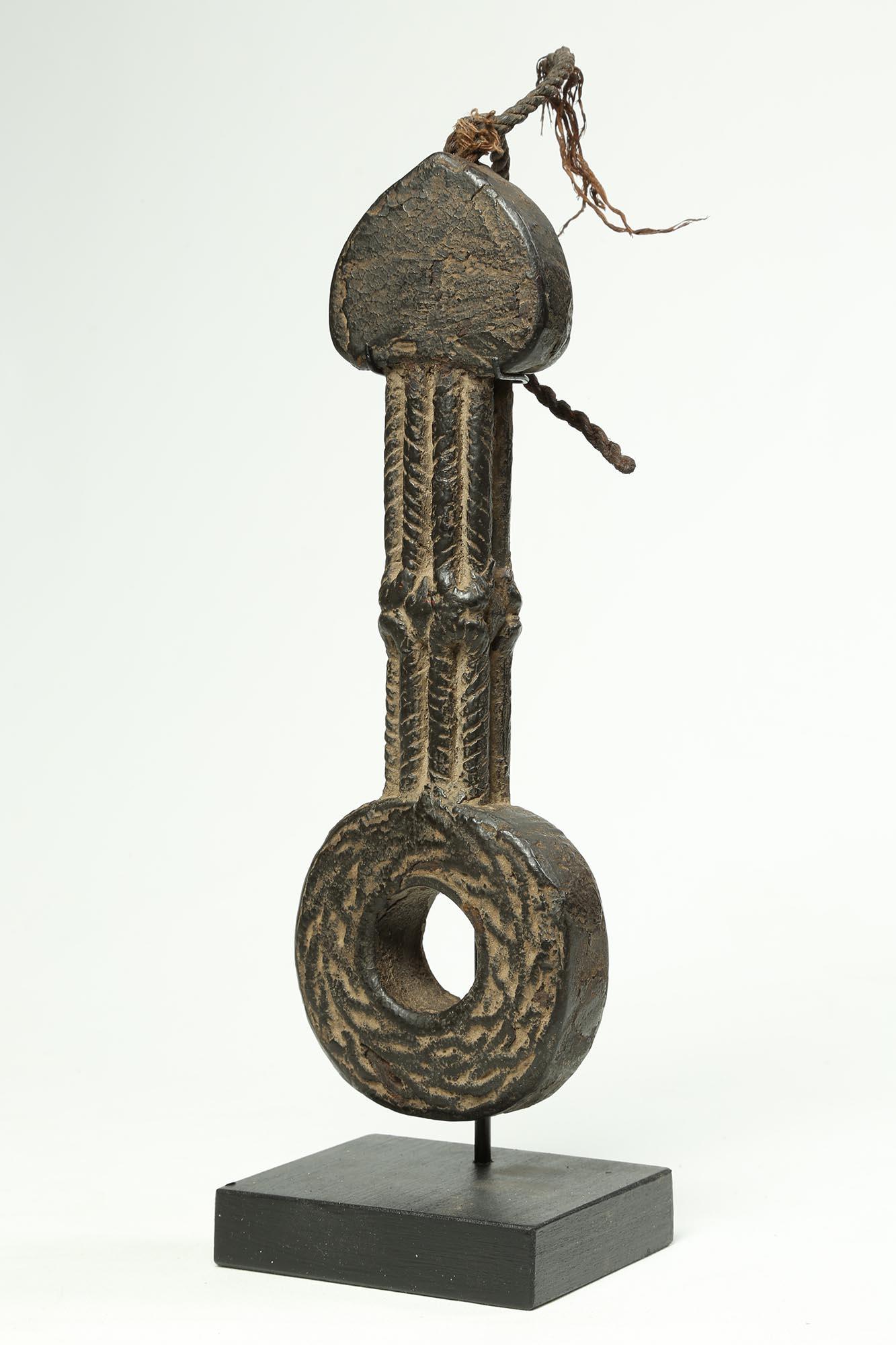 A old carved wood Nepal, North India or other Himalayan culture butter churn handle called a ghurra. Created in the early 20th century. The handle with braided columns rising to a heart-shaped top. Remains of the old cord used to connect to the