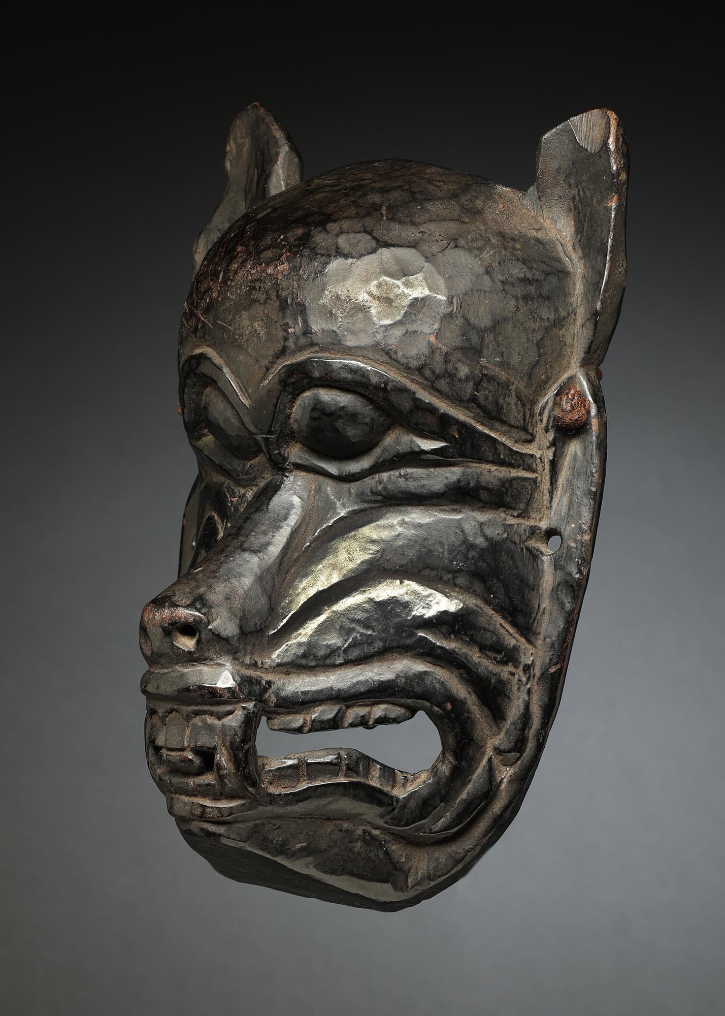 Wolf or similar animal mask from Nepal with alert ears, mouth with teeth and fangs. Deep old patina on front and inside from traditional use. Ex- private collection in Southwest, ex private collection, Colorado 1980's. Mask 10 1/2