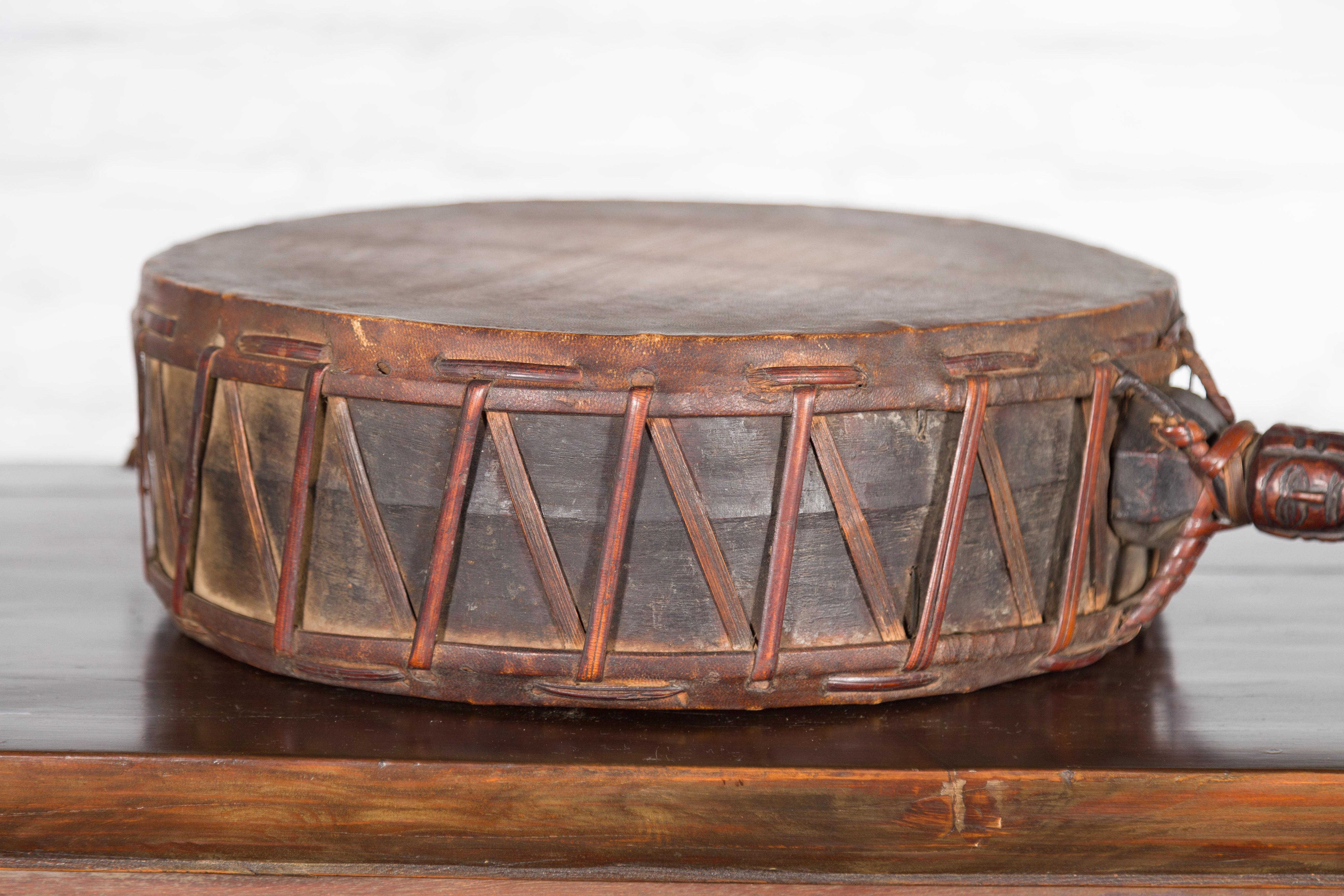 Rustic Nepalese Antique Leather Hand Drum with Carved Wooden Handle For Sale