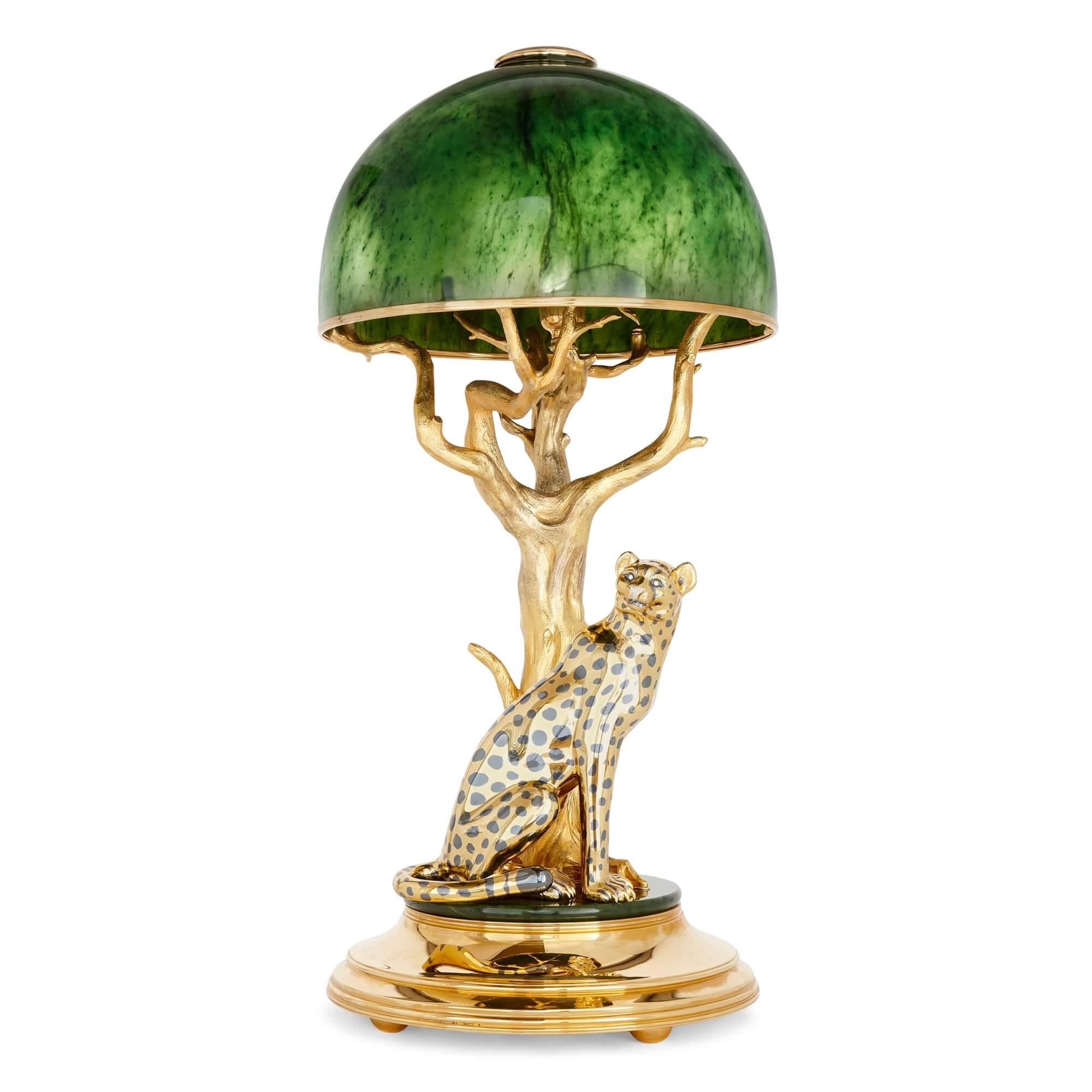 Nephrite, diamond, gilt metal lamp with a cheetah by Asprey 
English, c. 1980
Height 90cm, diameter 42cm

This superb sculptural lamp depicts a cheetah elegantly sitting under a tree. Made in around 1980, by the well-known English firm of Asprey,
