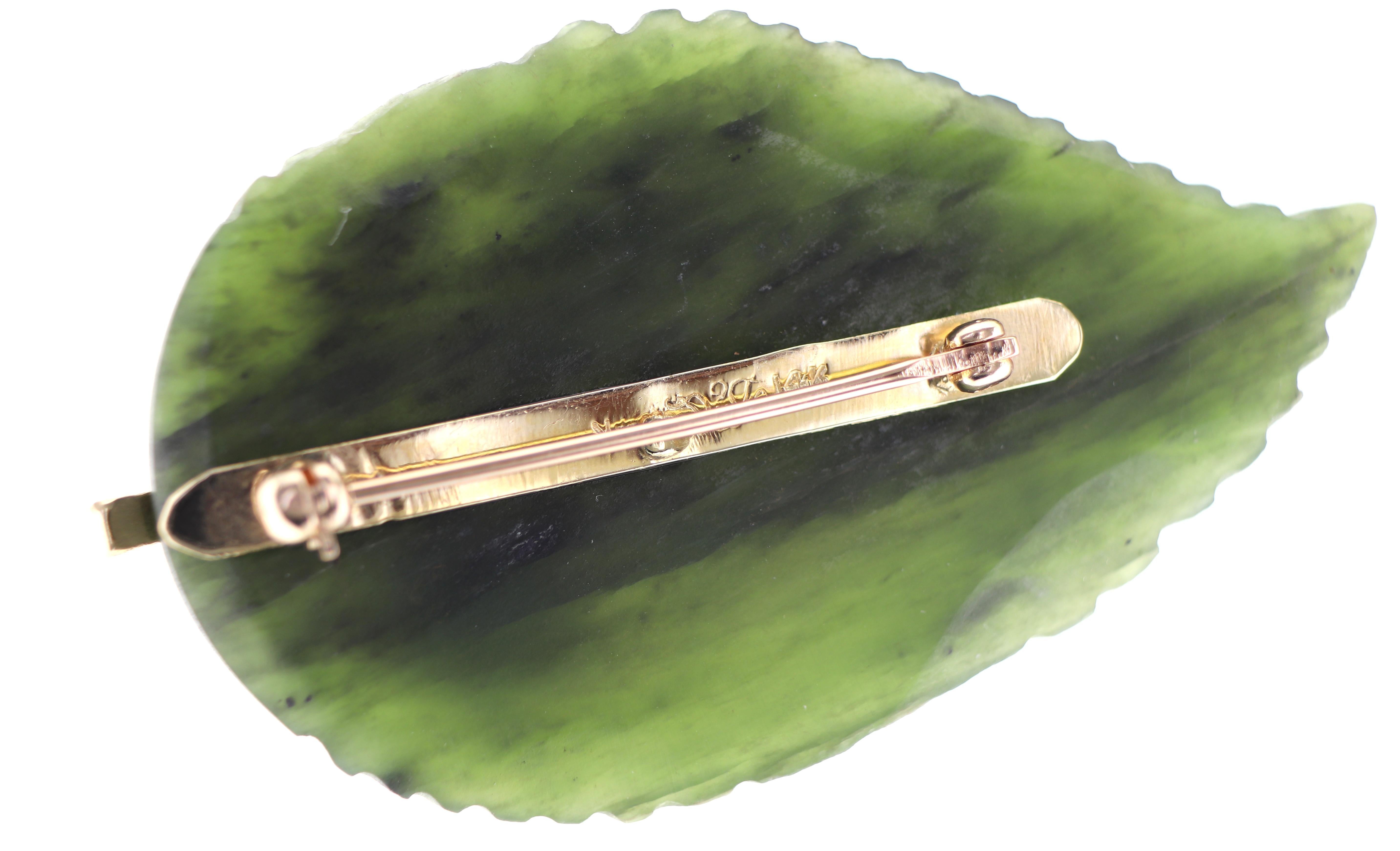 Featuring (1) carved nephrite leaf, 49.7 X 30.3 X 4.7 mm, accented by a textured 14k yellow gold tree and a 4 mm cultured pearl sun, marked 14K, logo, Gross weight 15.12 grams.