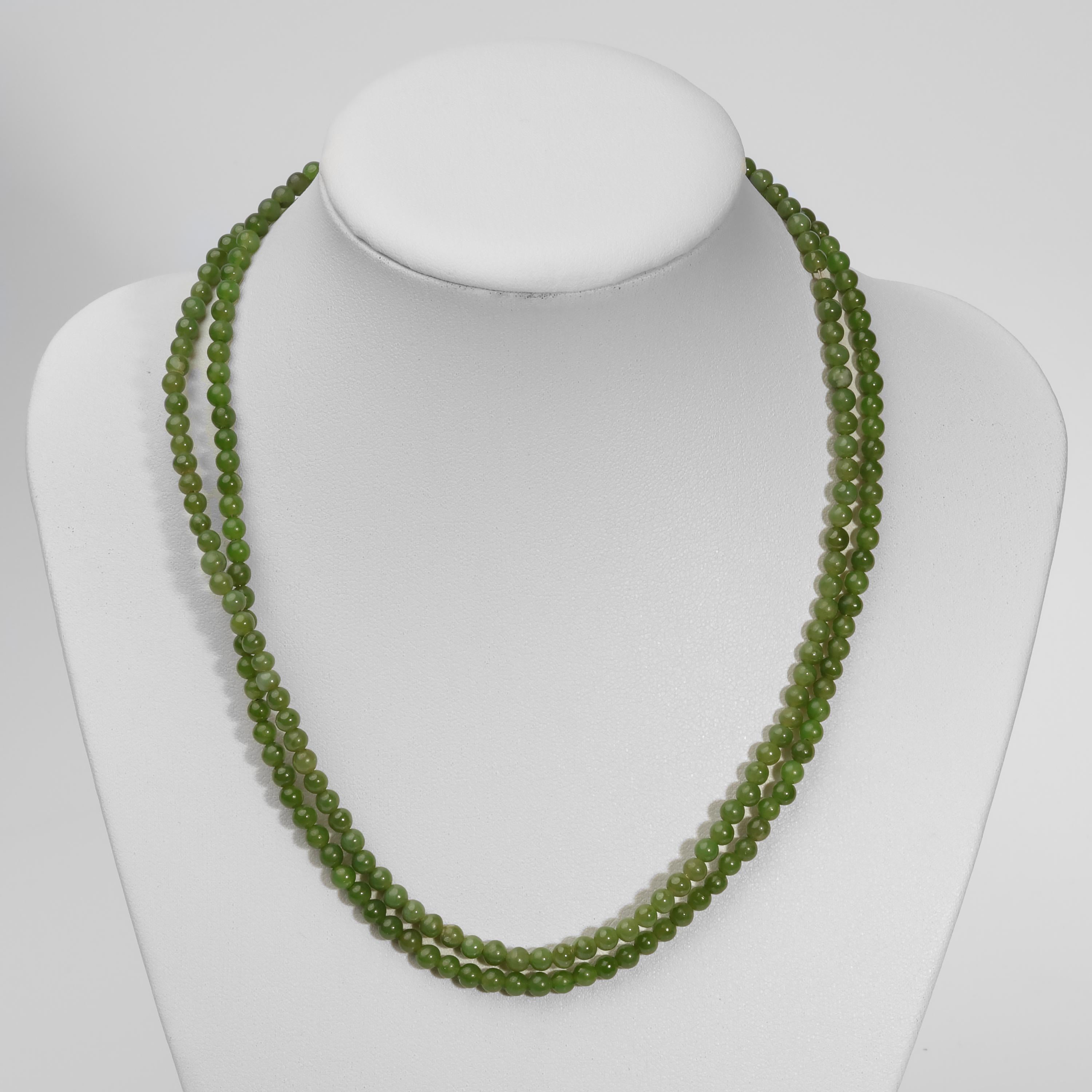 This interesting necklace is composed of 213 translucent nephrite jade beads, each hand-carved and measuring between approximately 4mm and 4.5mm. The beads are a very pleasing sage green and because of their excellent translucency, they are gemmy