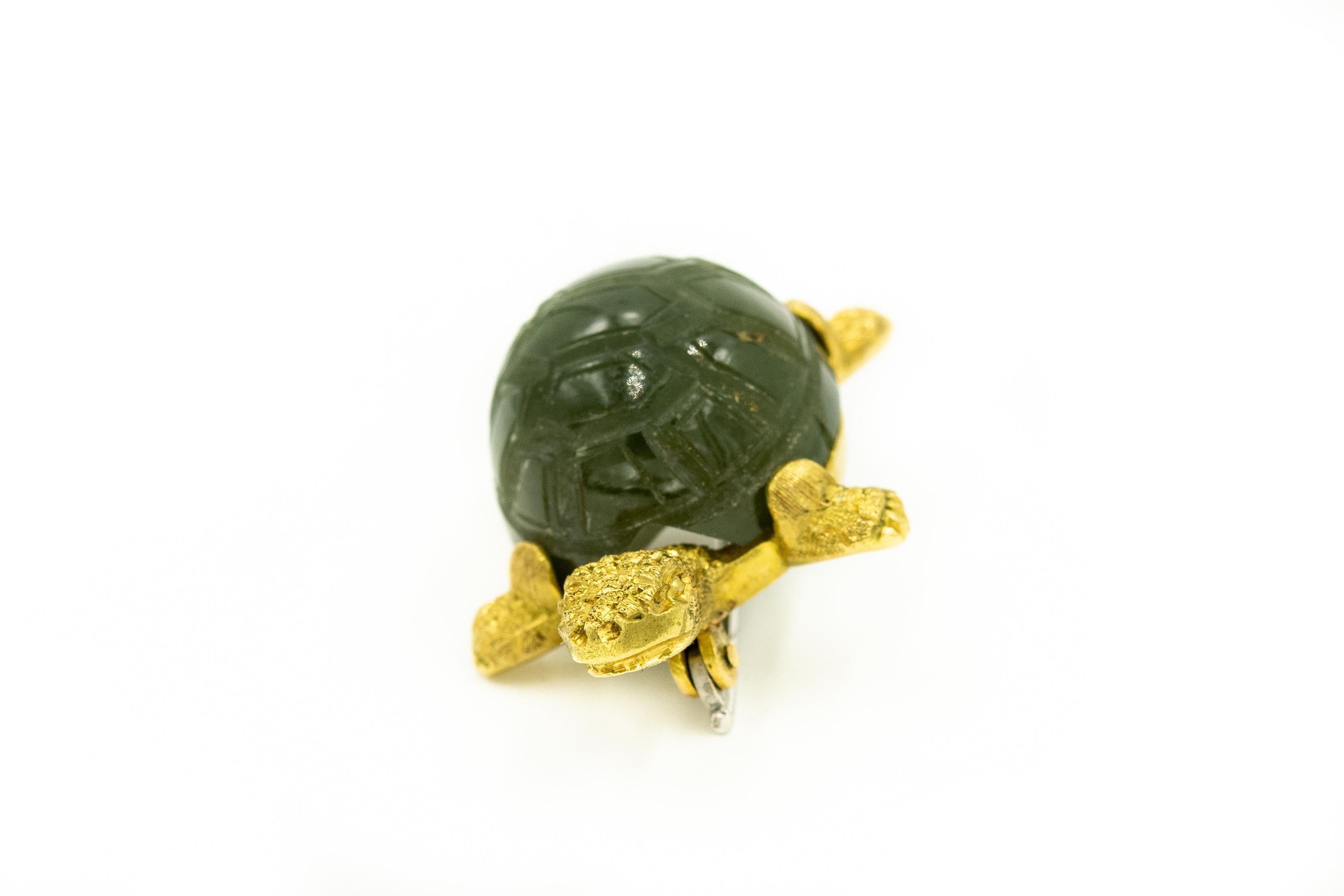 Adorable turtle brooch featuring a carved nephrite jade shell with textured 18k yellow gold head, legs and tail.  

It is marked 750 for 18k  most likely Italian.